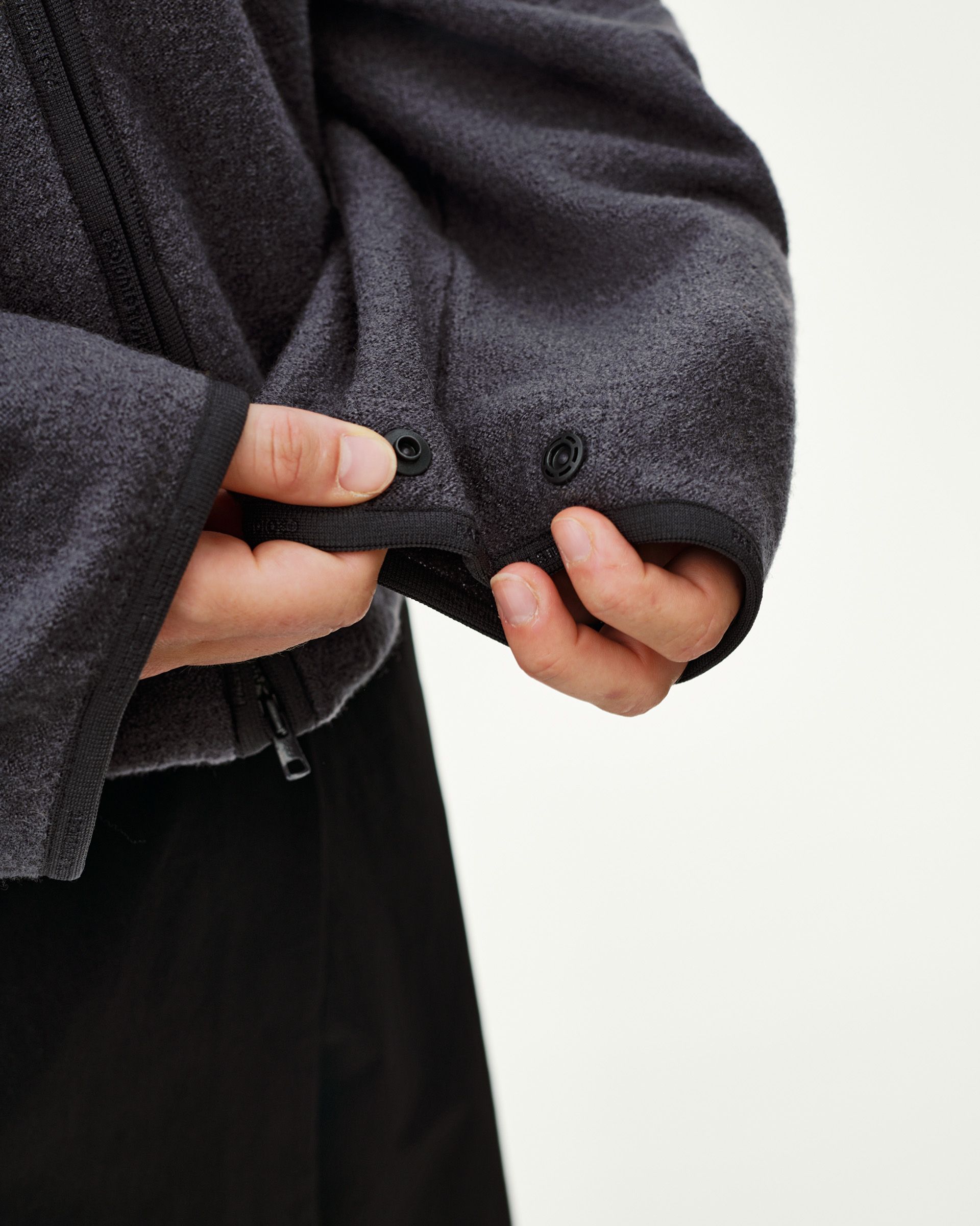 Steel grey Off-Race Boiled Wool jacket, detail view of cuff with snap buttons and side zip pocket