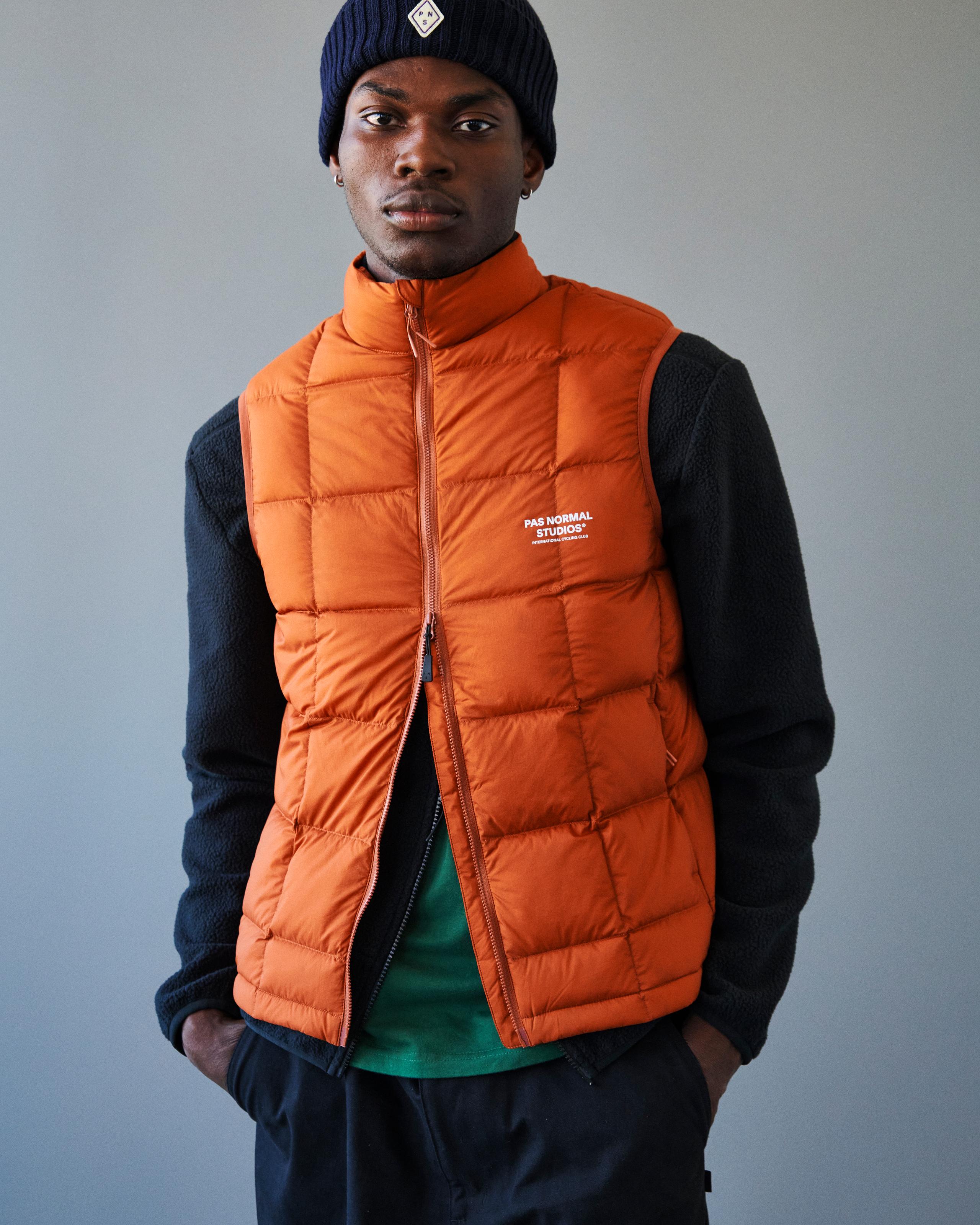 Orange Off-Race Down vest on model with quilted panels and full zip