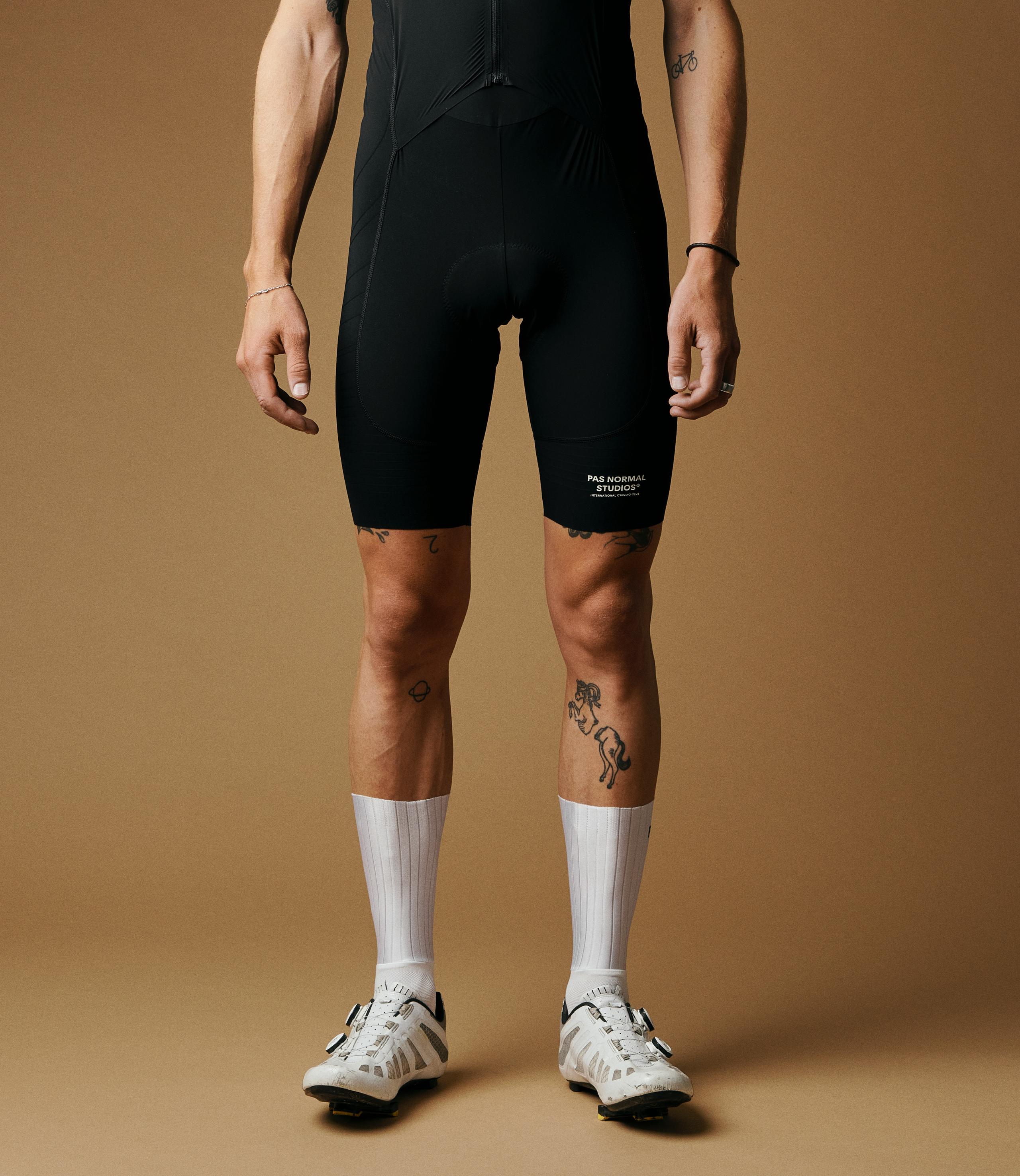 White Mechanism Aero cycling socks on model, ribbed design with black accents