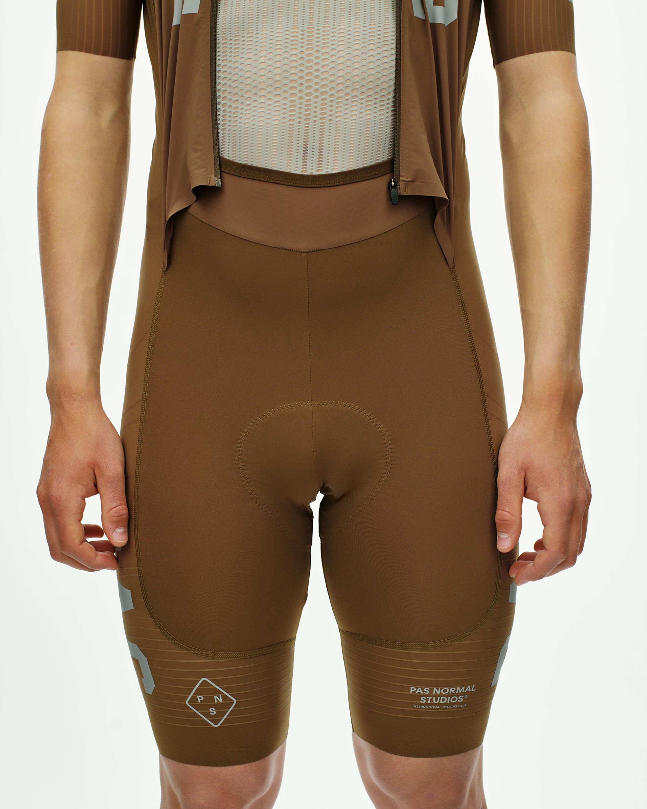 Brown PAS Mechanism Pro speedsuit, front view on model with mesh chest panel and contrast stitching