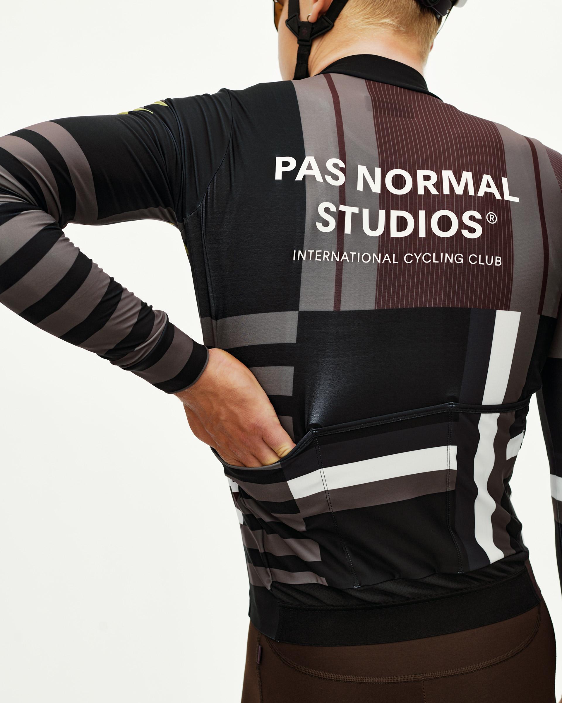 Dark Olive Mechanism long sleeve cycling jersey on model, rear view with multicolour block stripe print and back pockets