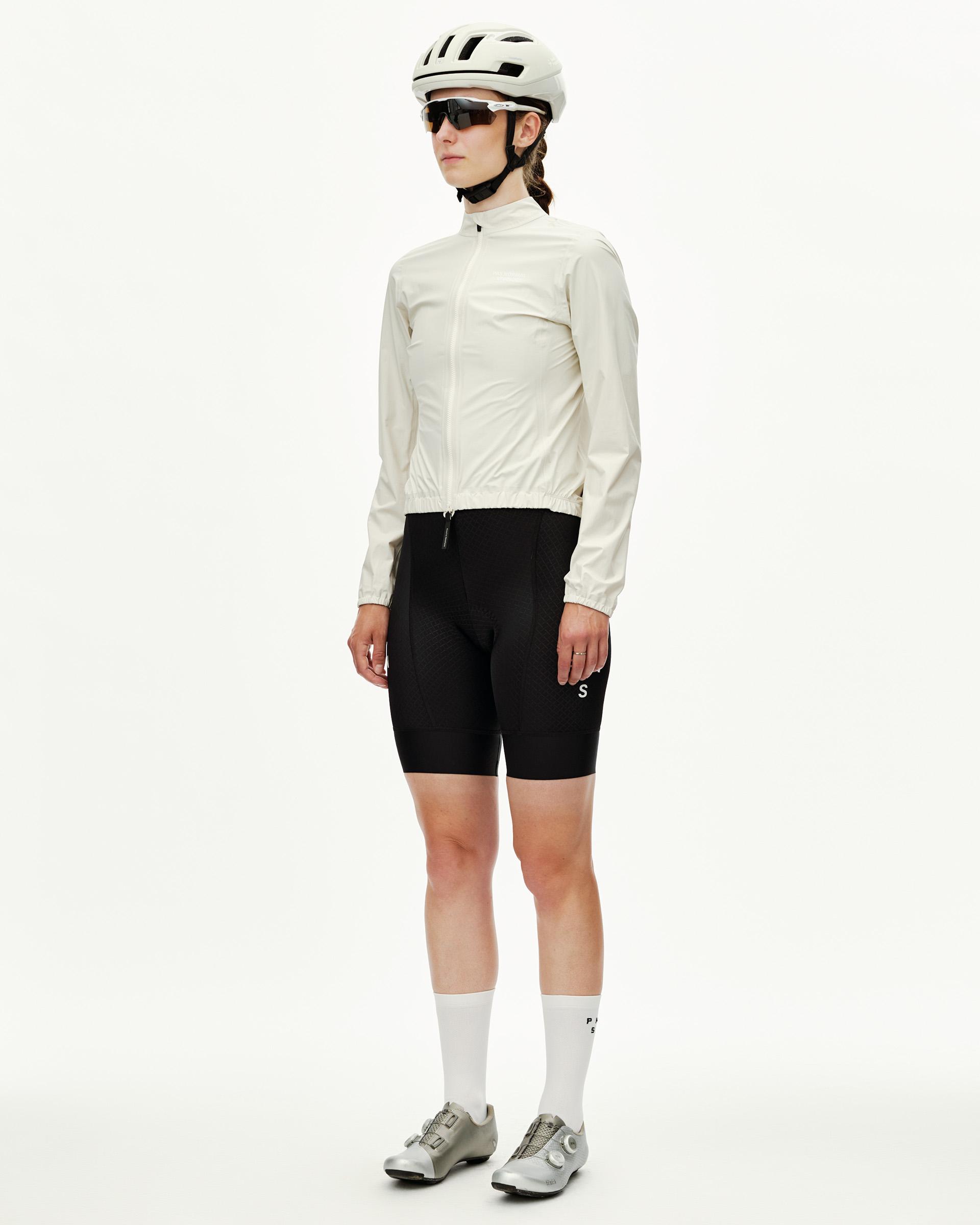 Off White Mechanism women's cycling rain jacket on model, three-quarter front view with elastic hem