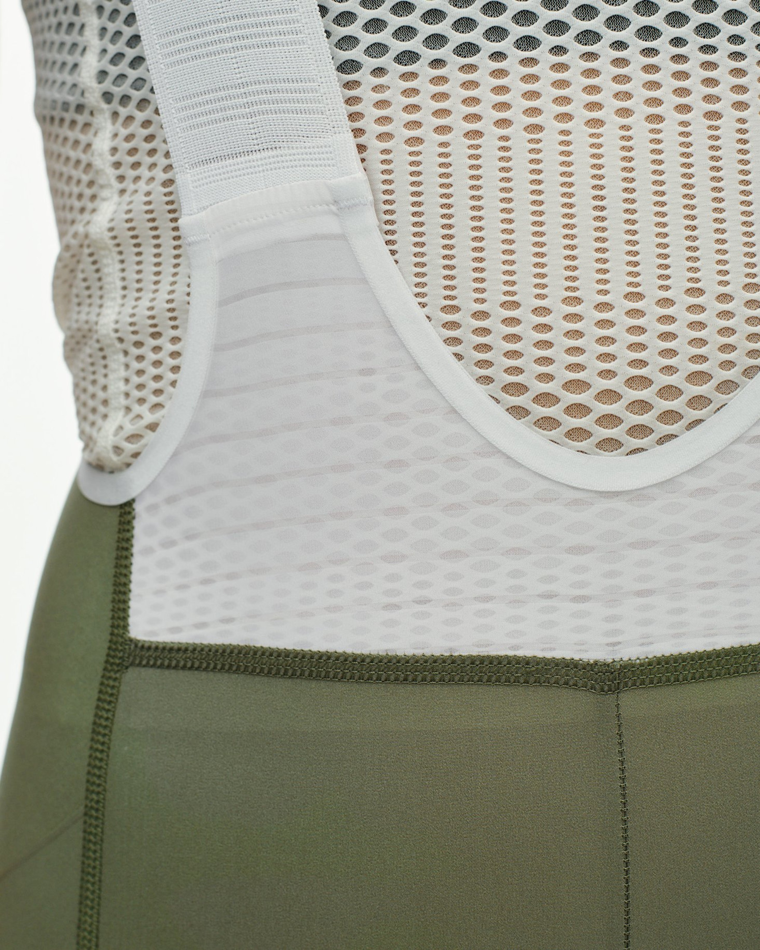 Green PAS Mechanism Pro bibs, detail view showing white mesh bib straps and waistband