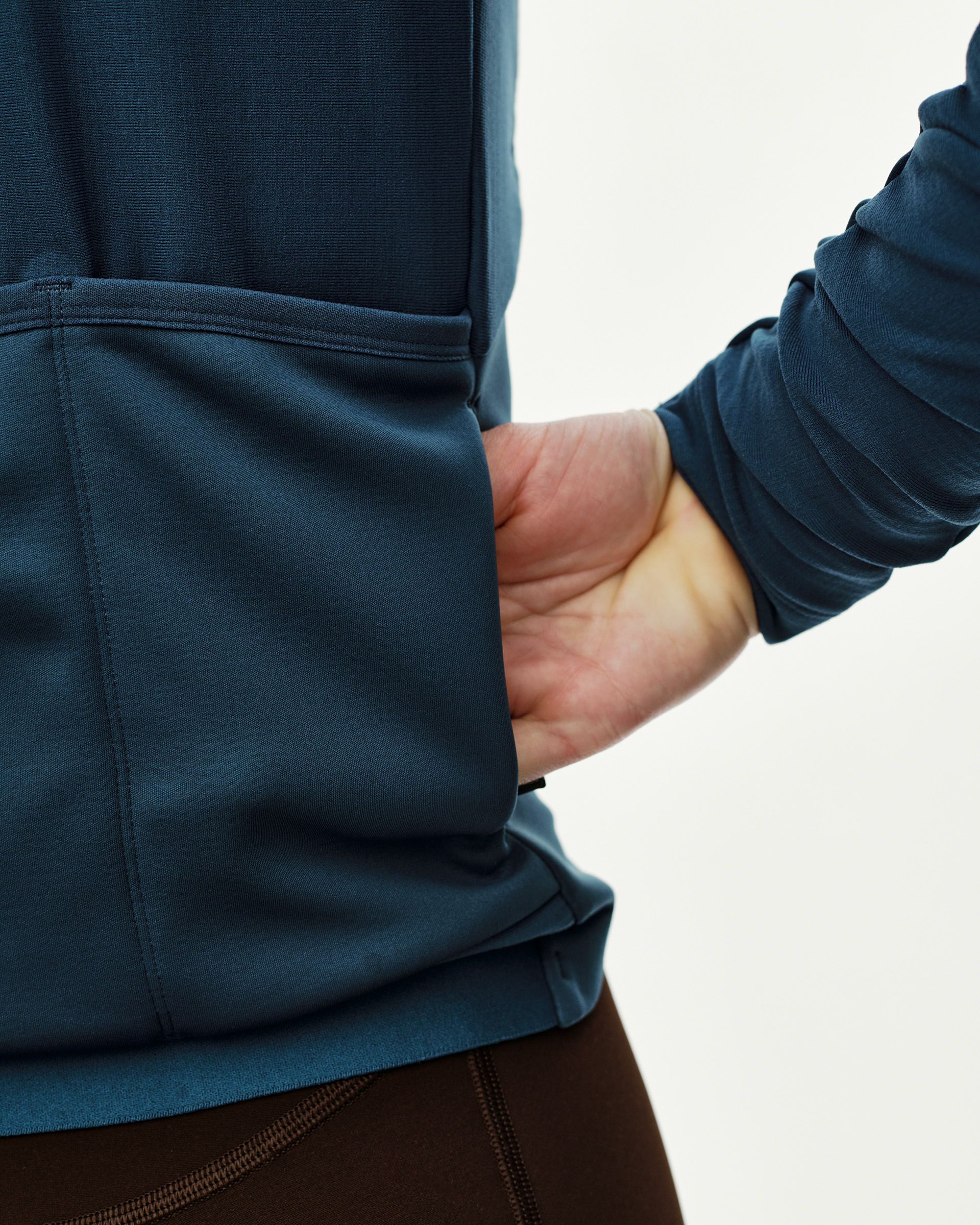 Denim Blue Mechanism Thermal Long Sleeve cycling jersey, side detail on model showing hand pocket