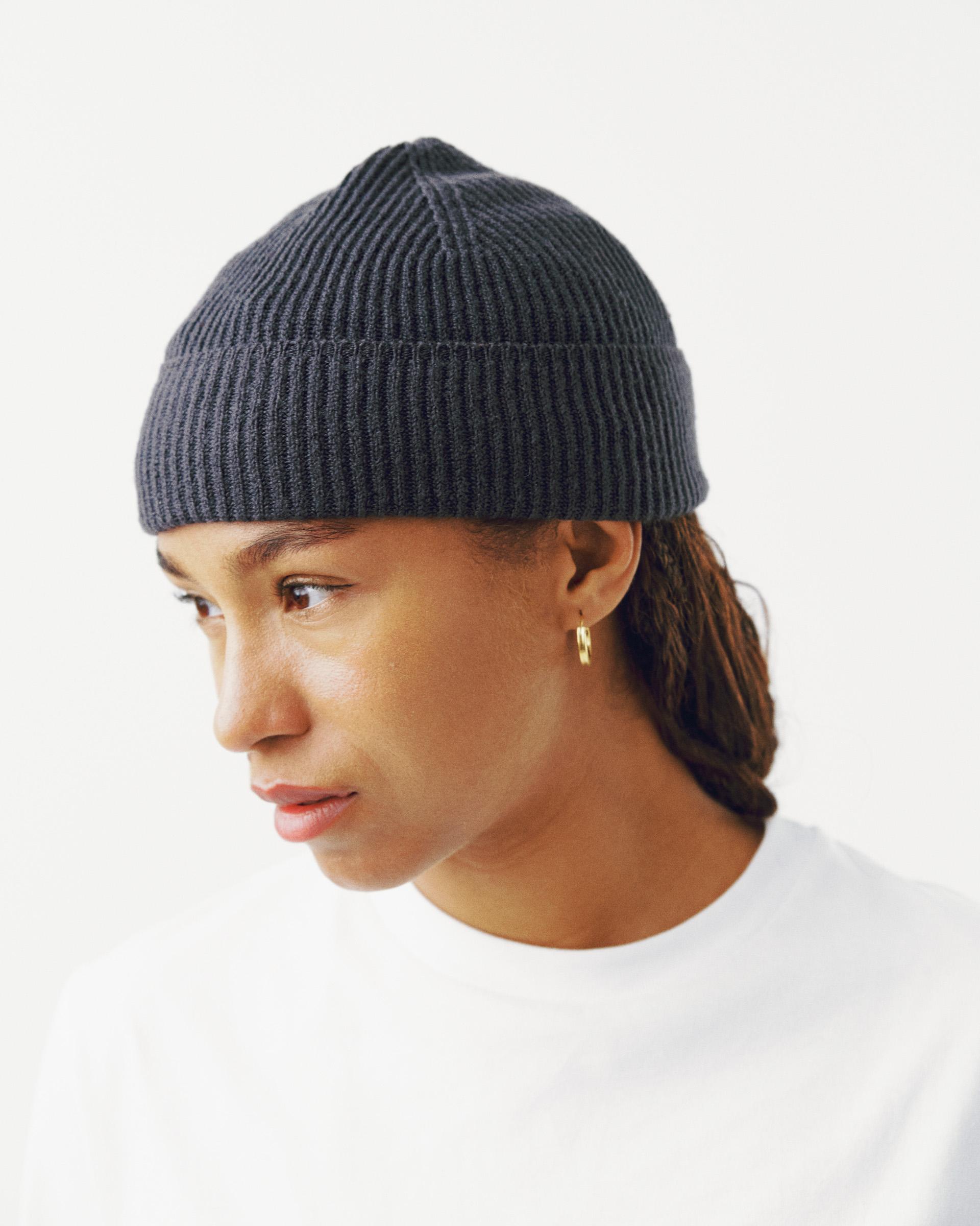 Grey Off-Race Merino Knit beanie on model, side view with ribbed knit texture