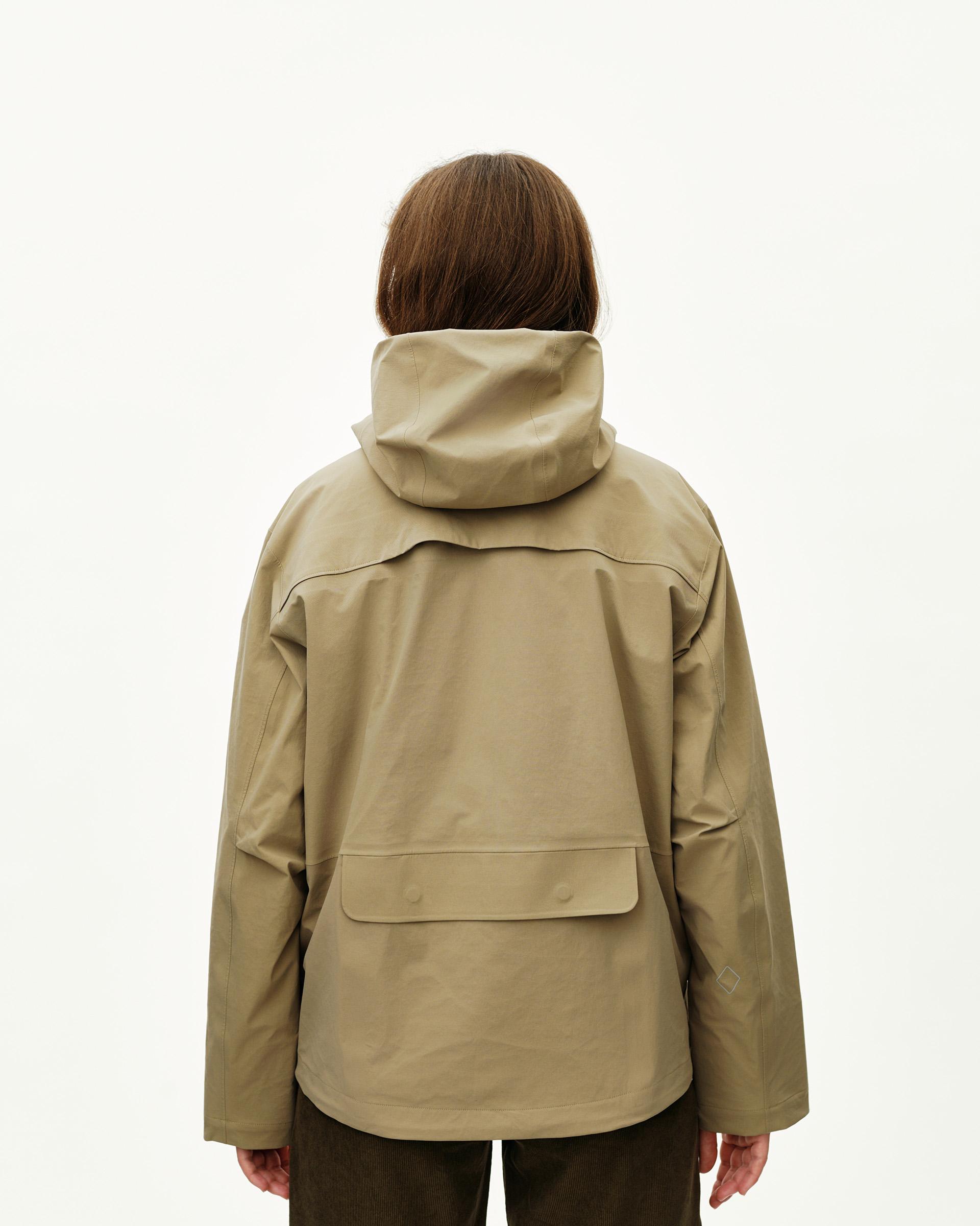 Dusty Earth khaki Off-Race 3L Shell jacket on model, rear view with storm hood and back pocket flap