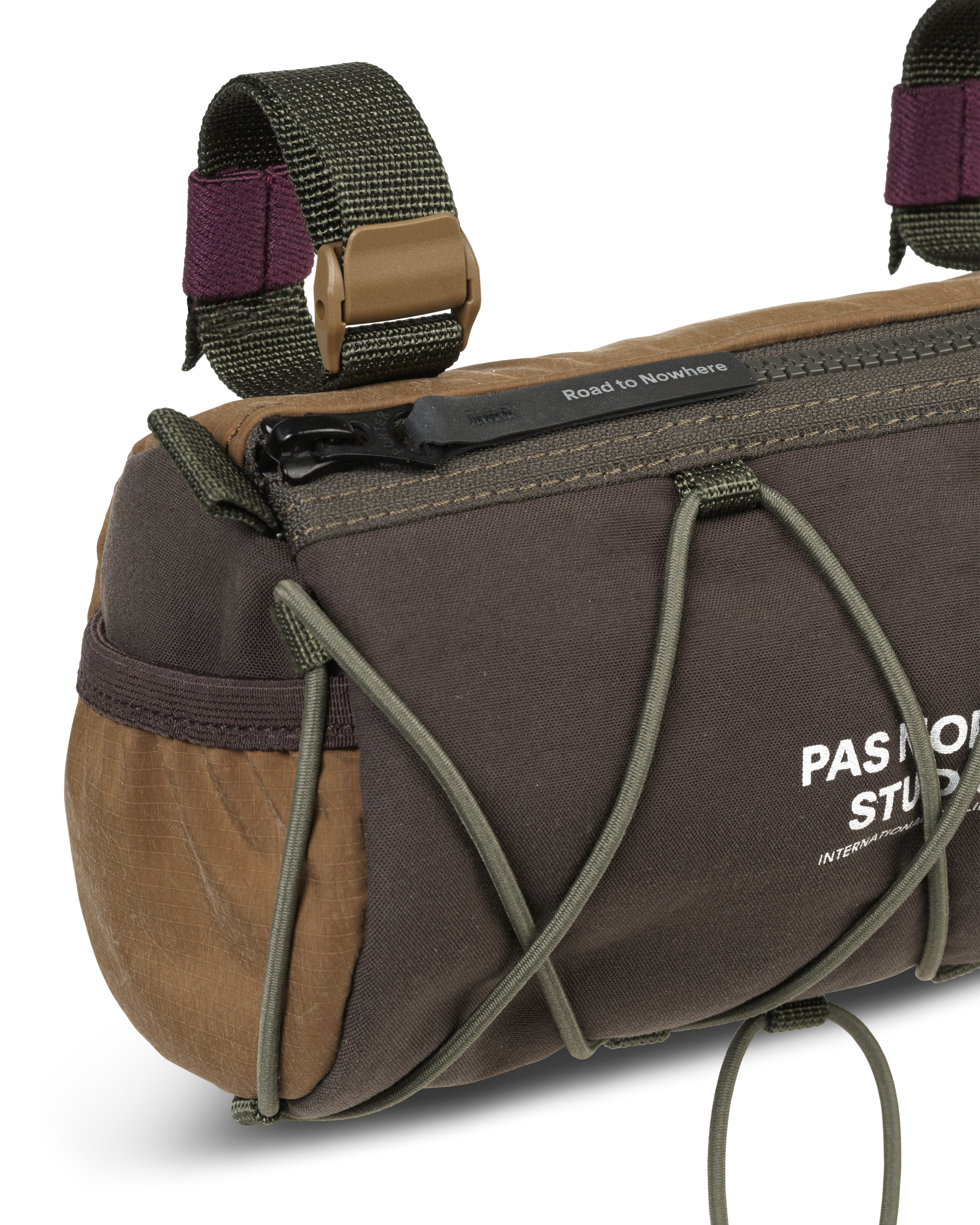 Light Brown Porter-Yoshida handlebar bag, detail view with olive bungee cord and contrast burgundy straps