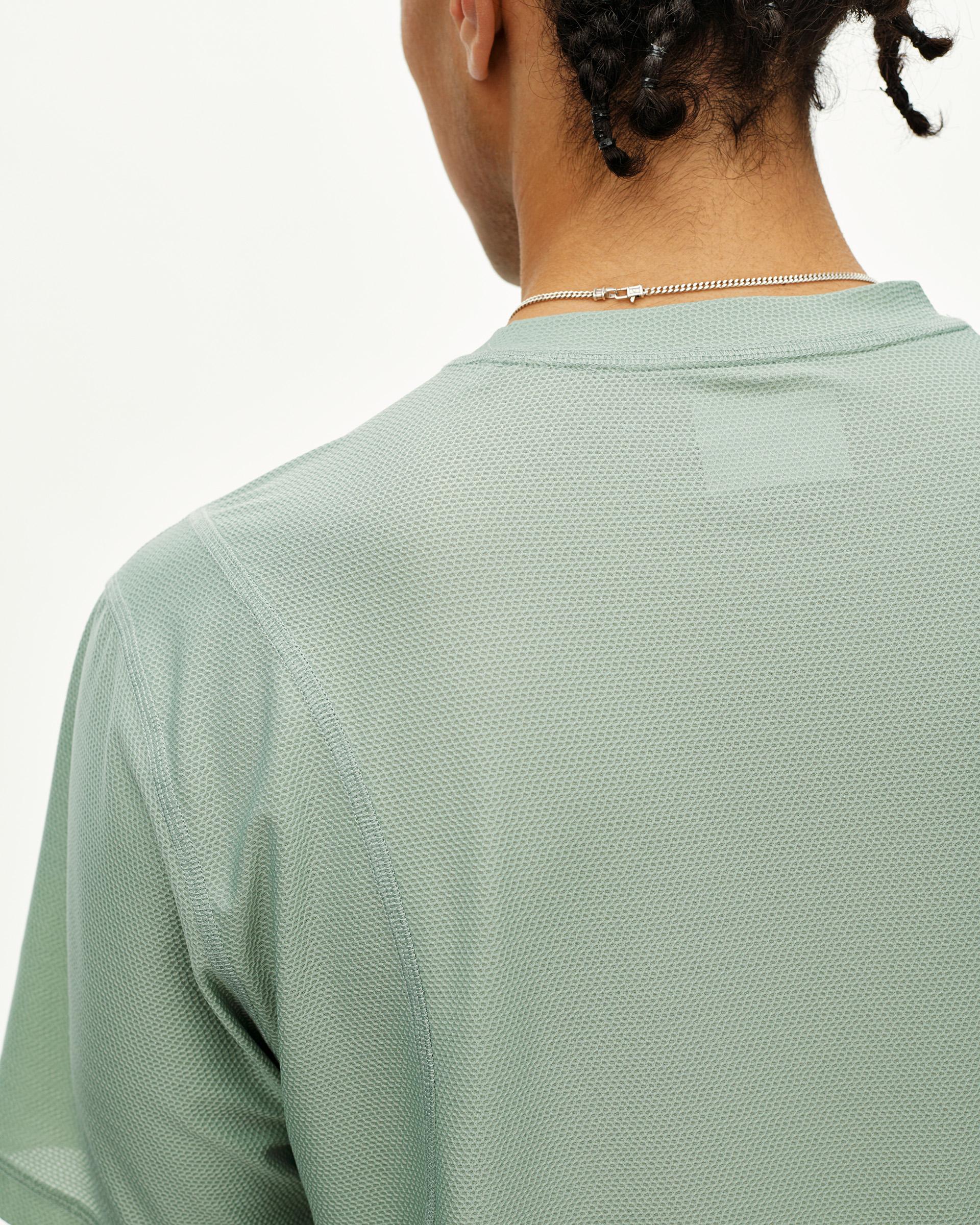 Green Sage Balance T-Shirt, rear detail on model with textured mesh fabric