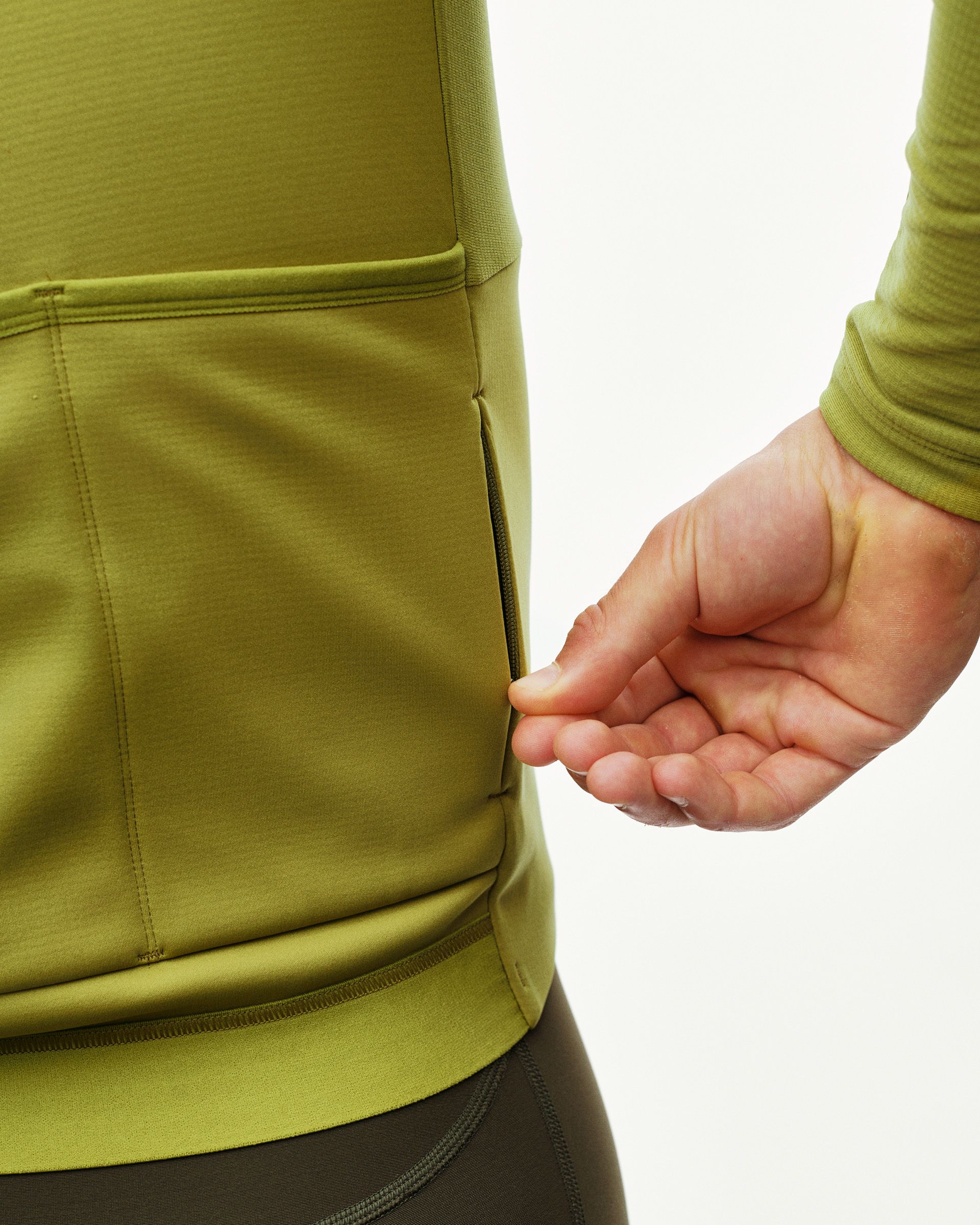 Dark Lime PAS Mechanism Thermal Long Sleeve cycling jersey, rear detail on model showing zipped pocket