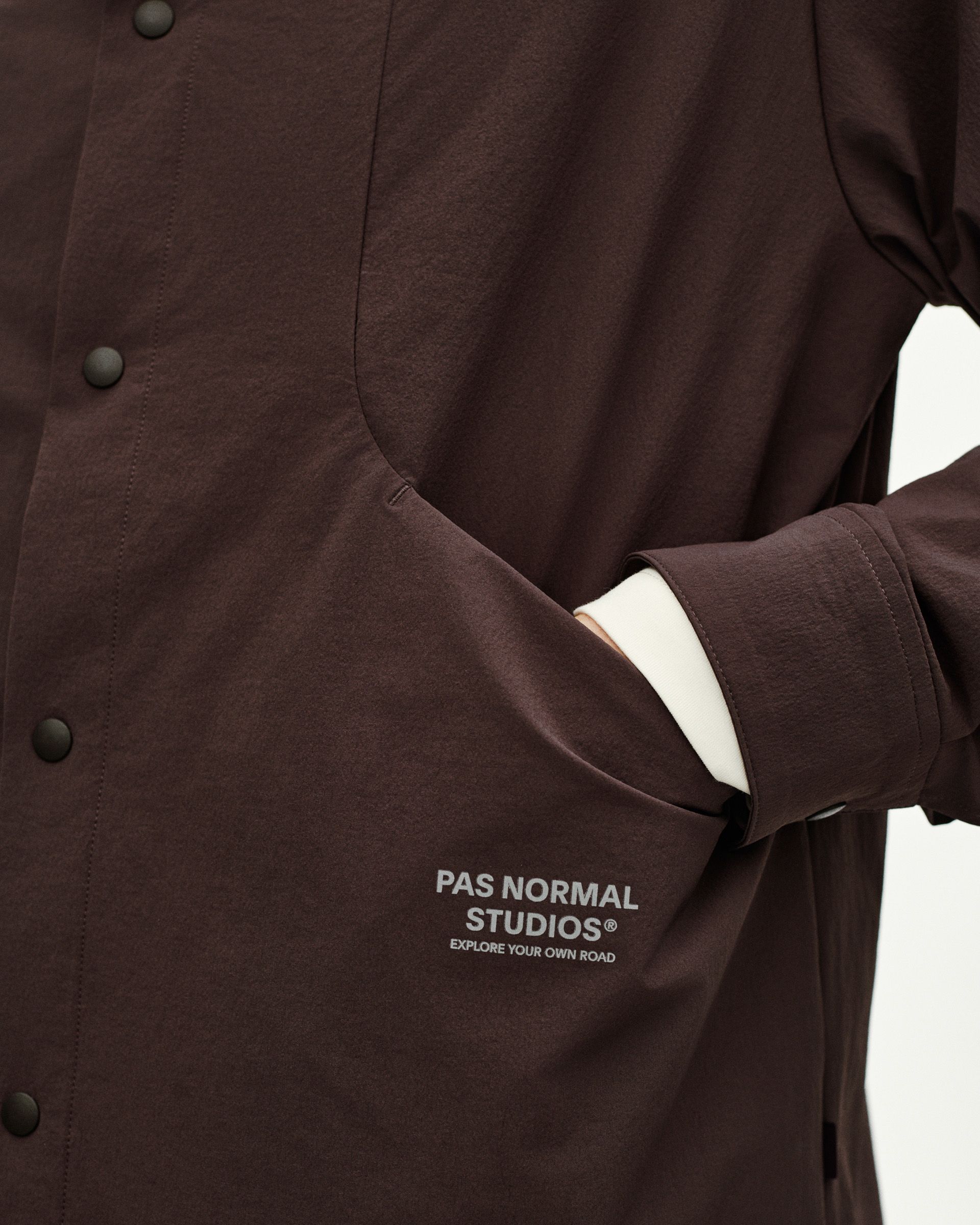 Dark Purple Off-Race Tech Overshirt, detail view showing snap buttons and chest pocket with white logo print