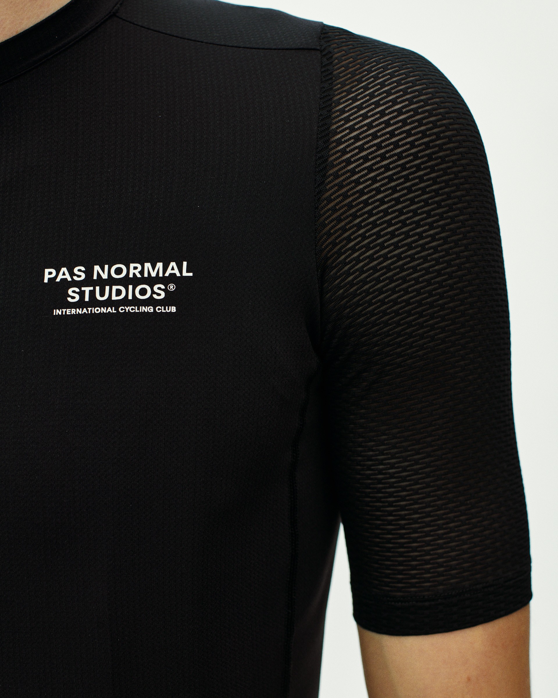 Black Essential Light cycling jersey on model with textured sleeve panel