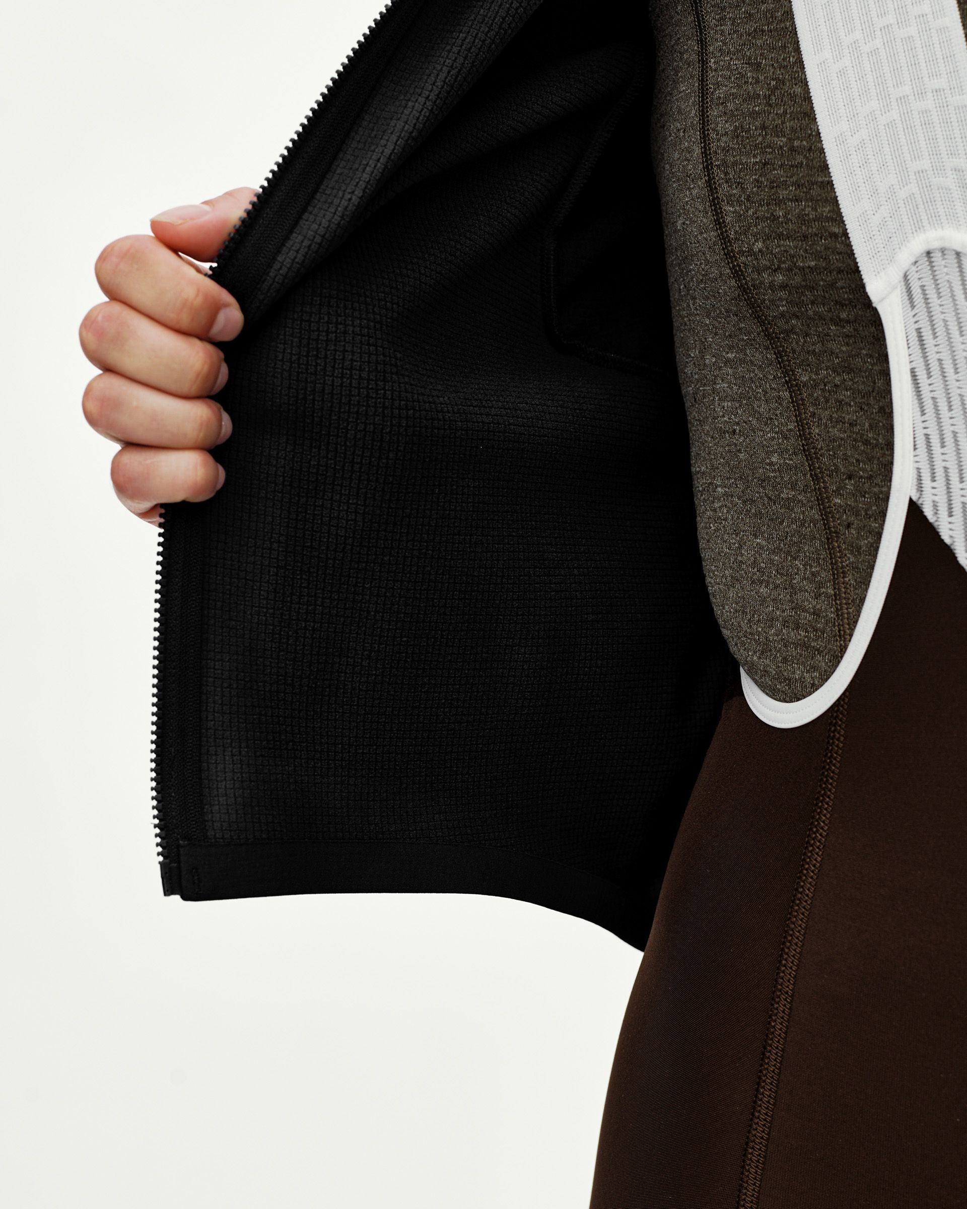 Black Mechanism women's thermal long sleeve cycling jersey, detail view showing opened zip and grid-fleece inner lining