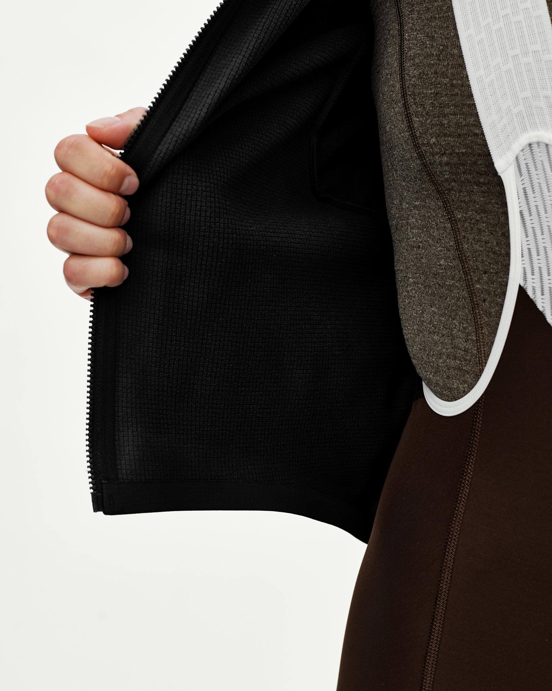 Black Mechanism women's thermal long sleeve cycling jersey, detail view showing opened zip and grid-fleece inner lining