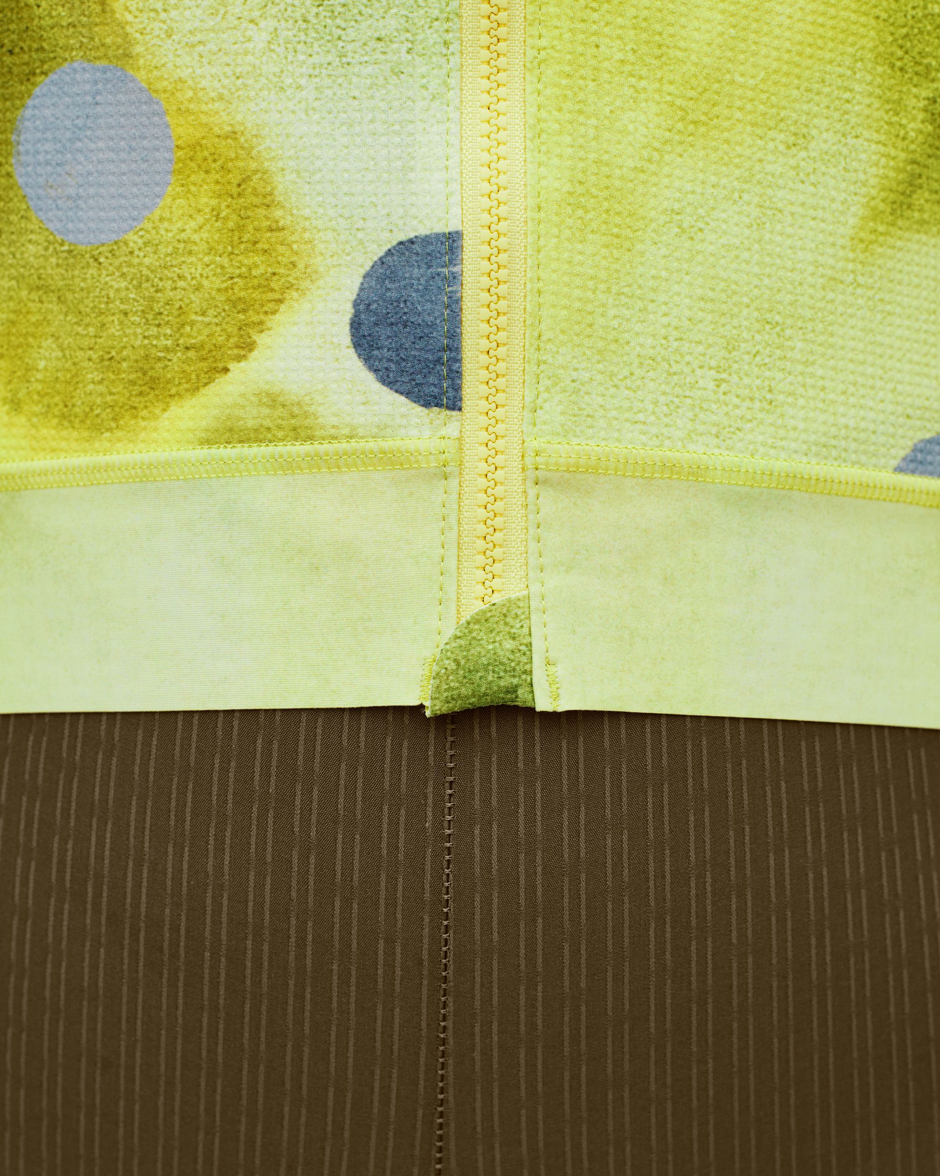 Yellow T.K.O. Essential Light cycling jersey, detail view showing painted circle print and contrast stitching