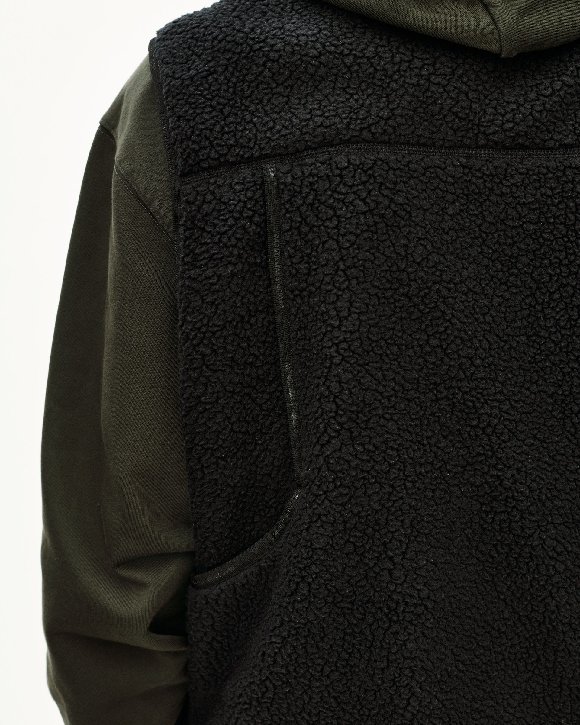 Dark Olive Off-Race Pile Fleece Vest, detail view showing sherpa body with contrast smooth olive sleeve panel and zip pocket