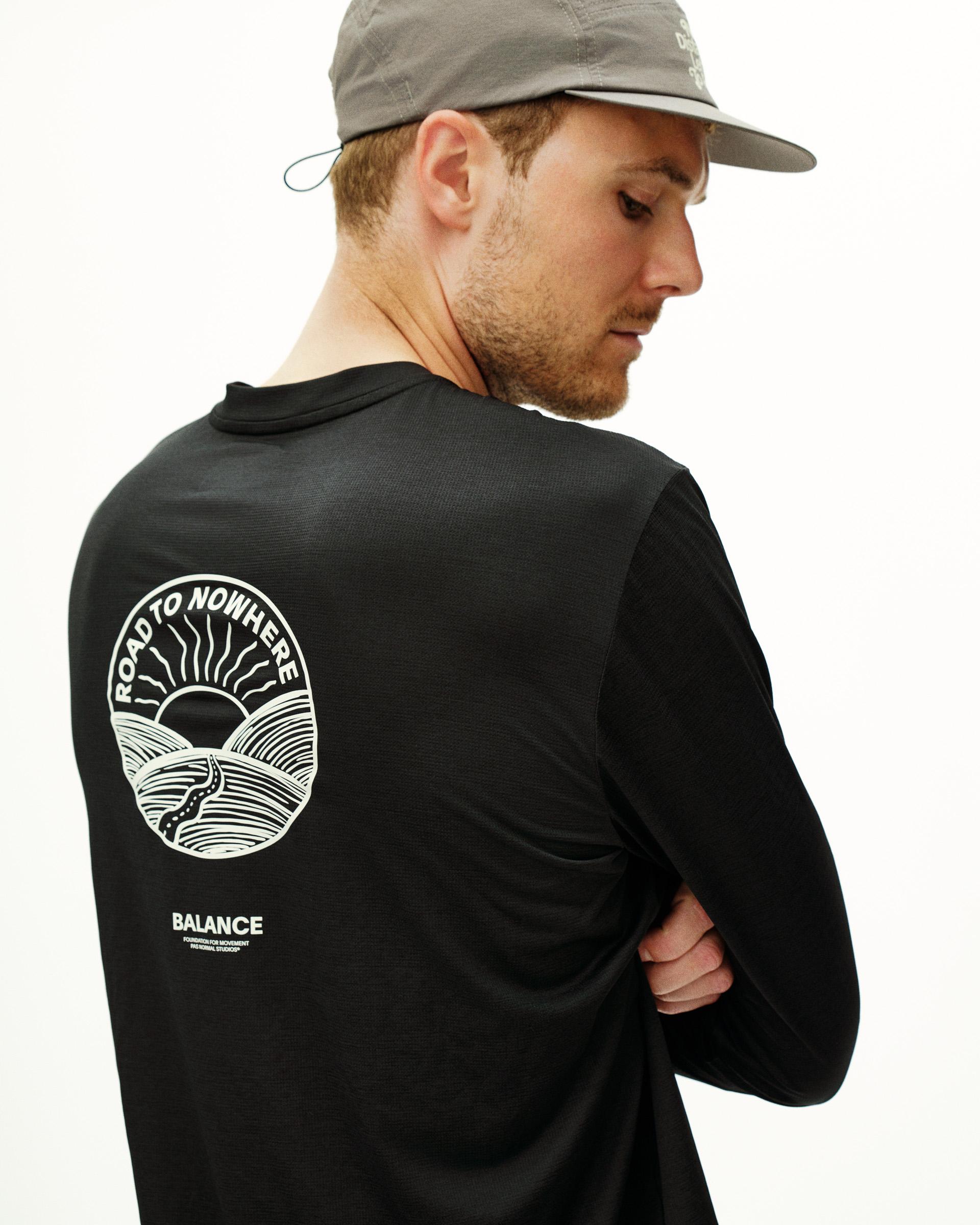 Black Balance long sleeve T-shirt on model, rear view with white Road to Nowhere graphic print