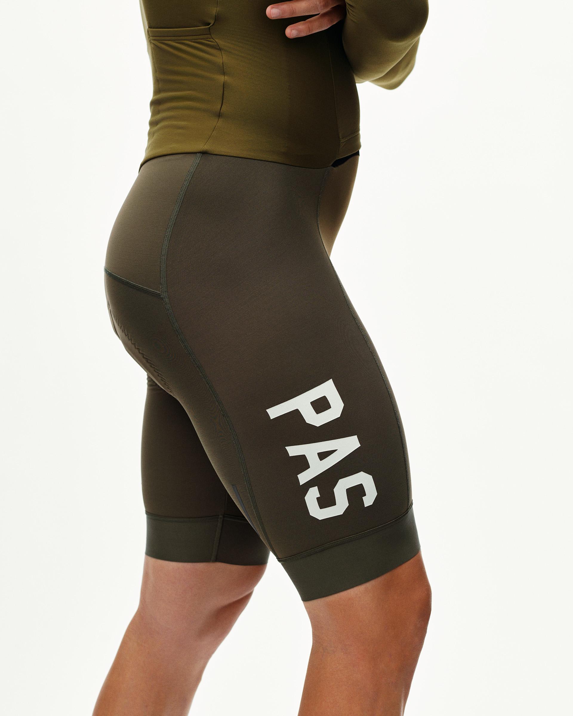 Moss Brown PAS thermal cycling speedsuit on model, side view with white PAS leg print