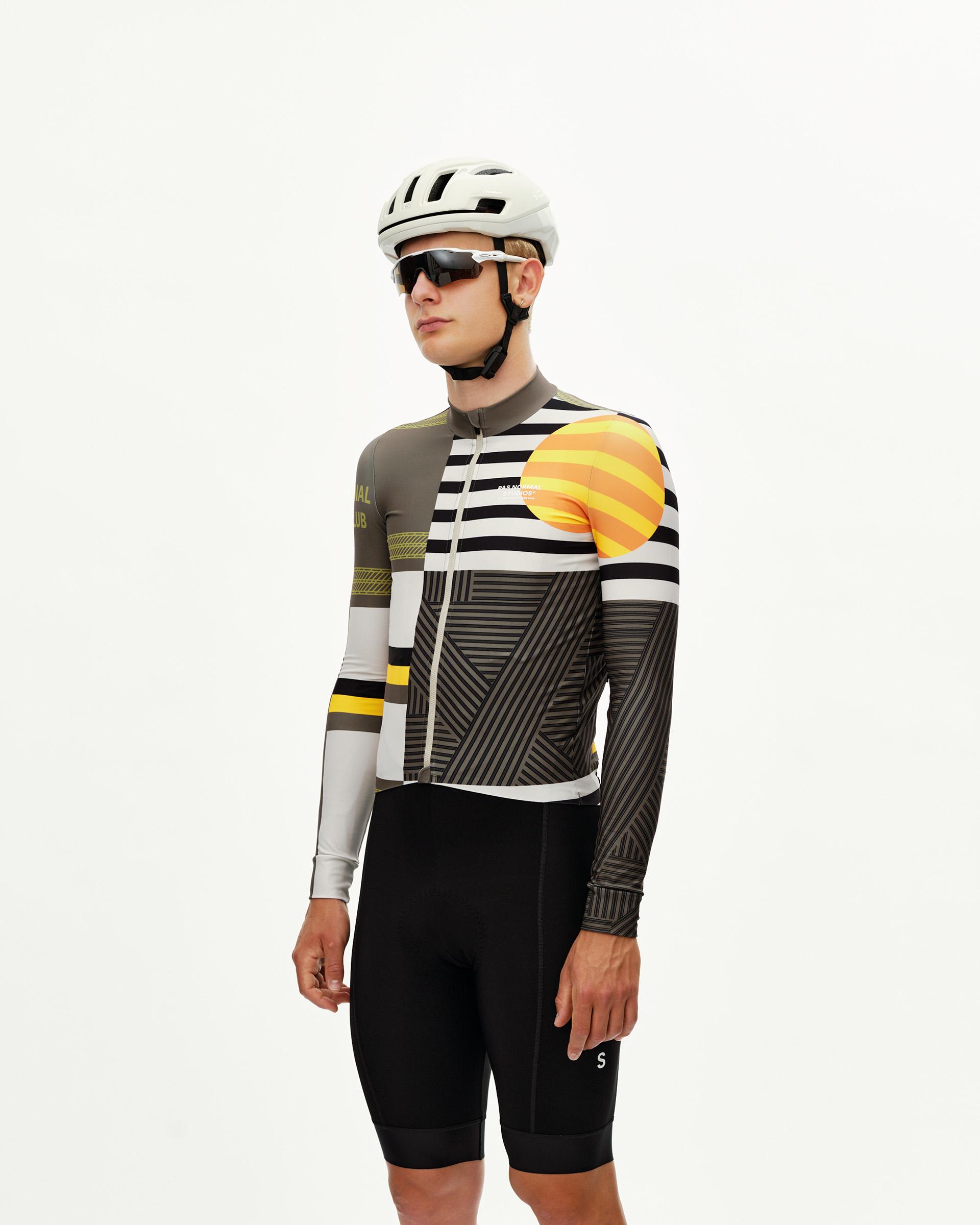 International Sand Mechanism long sleeve cycling jersey on model, three-quarter front view with multicolour geometric print