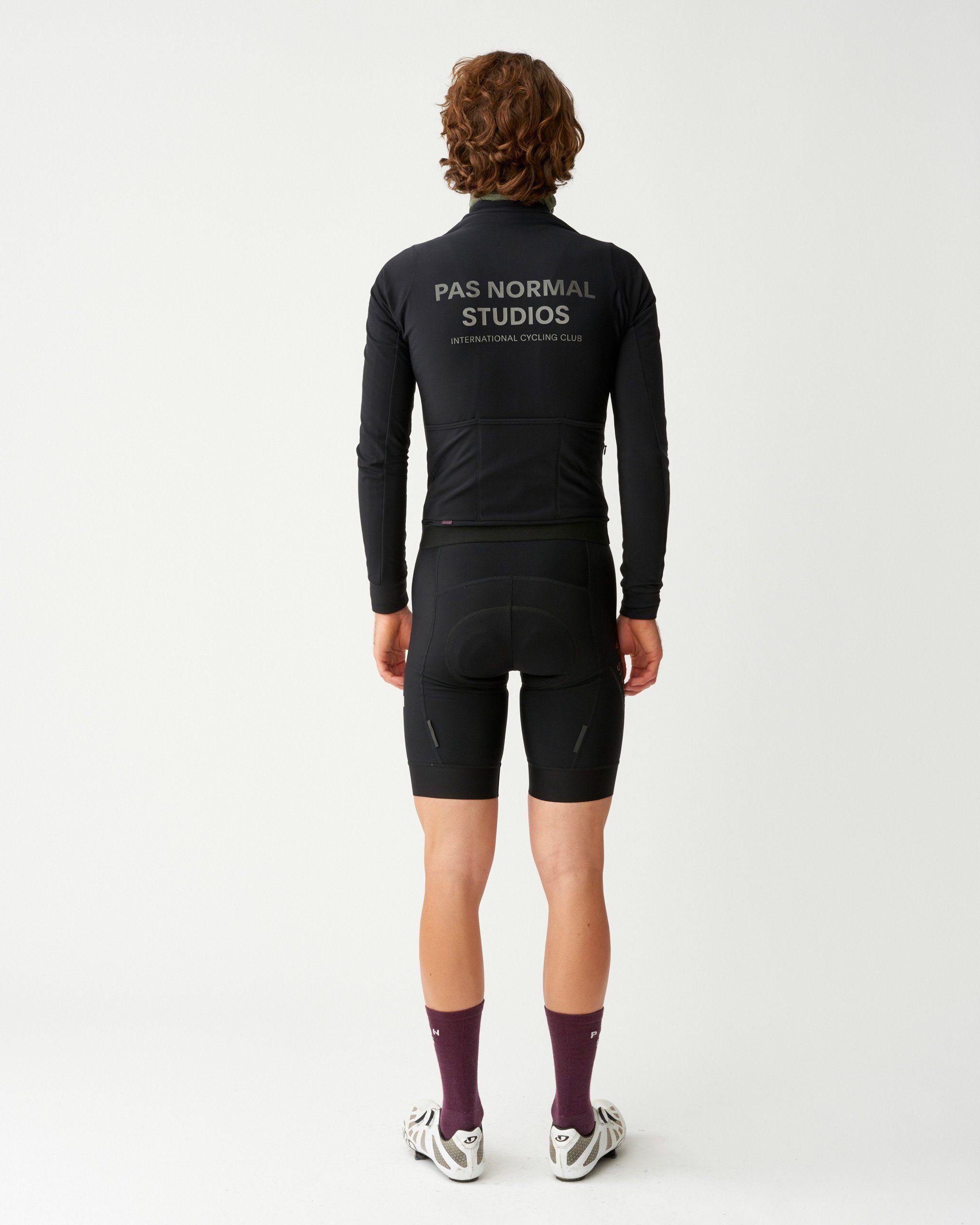 Black Mechanism Thermal long sleeve cycling jersey on model, rear view with grey back print