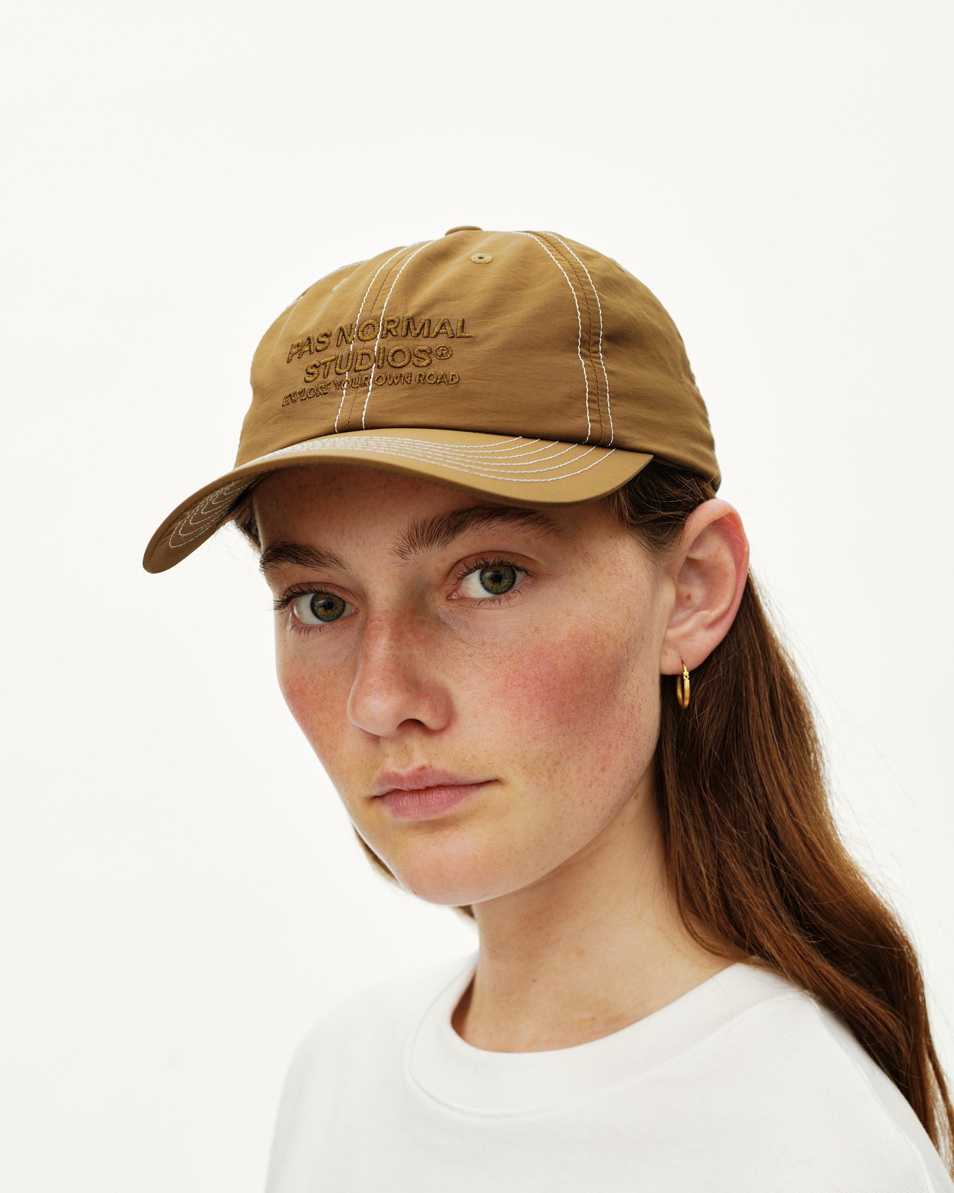 Wood brown Off-Race cap on model, front view with contrast white stitching and tonal embroidered logo
