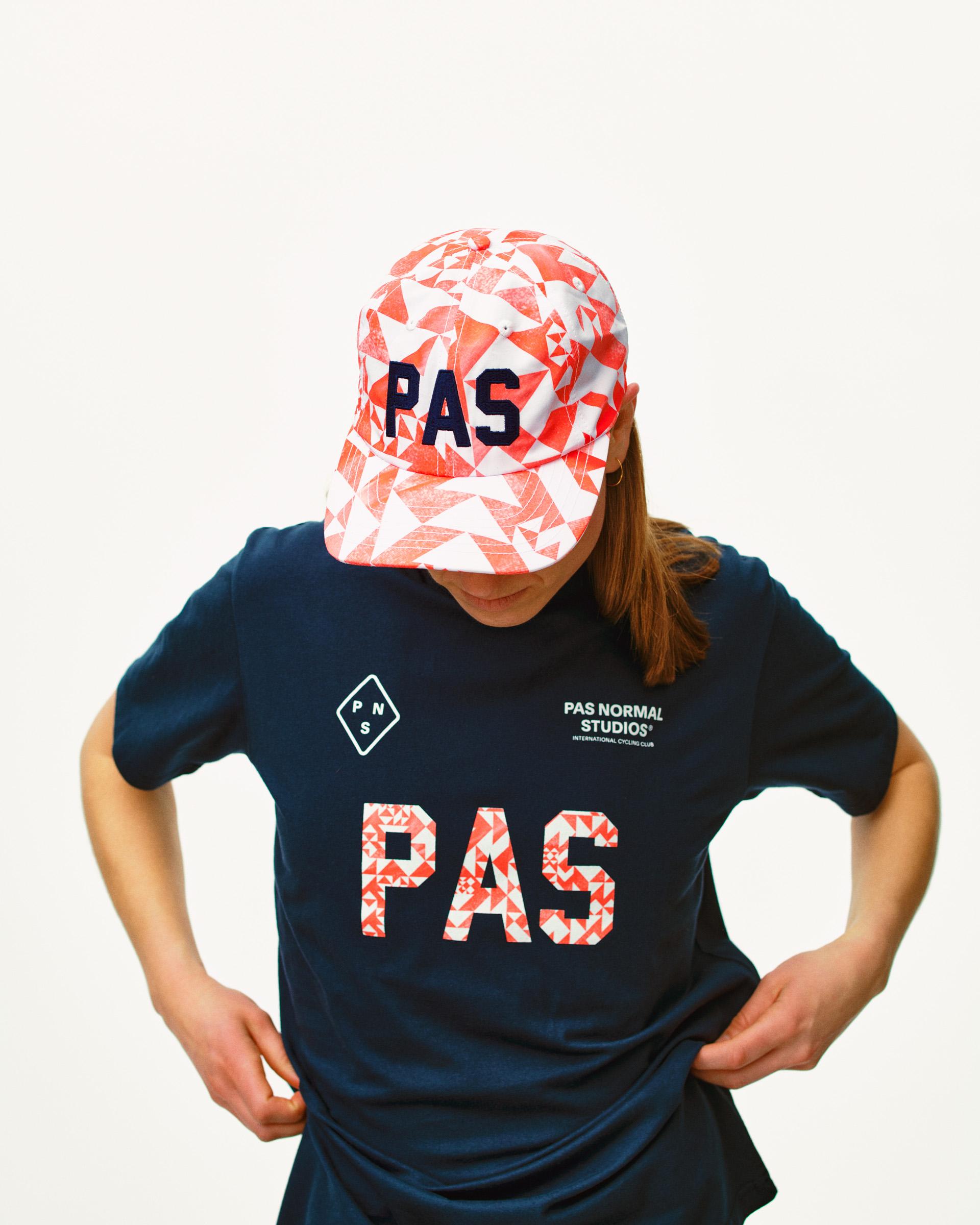Orange PAS Off-Race cap on model with geometric origami pattern