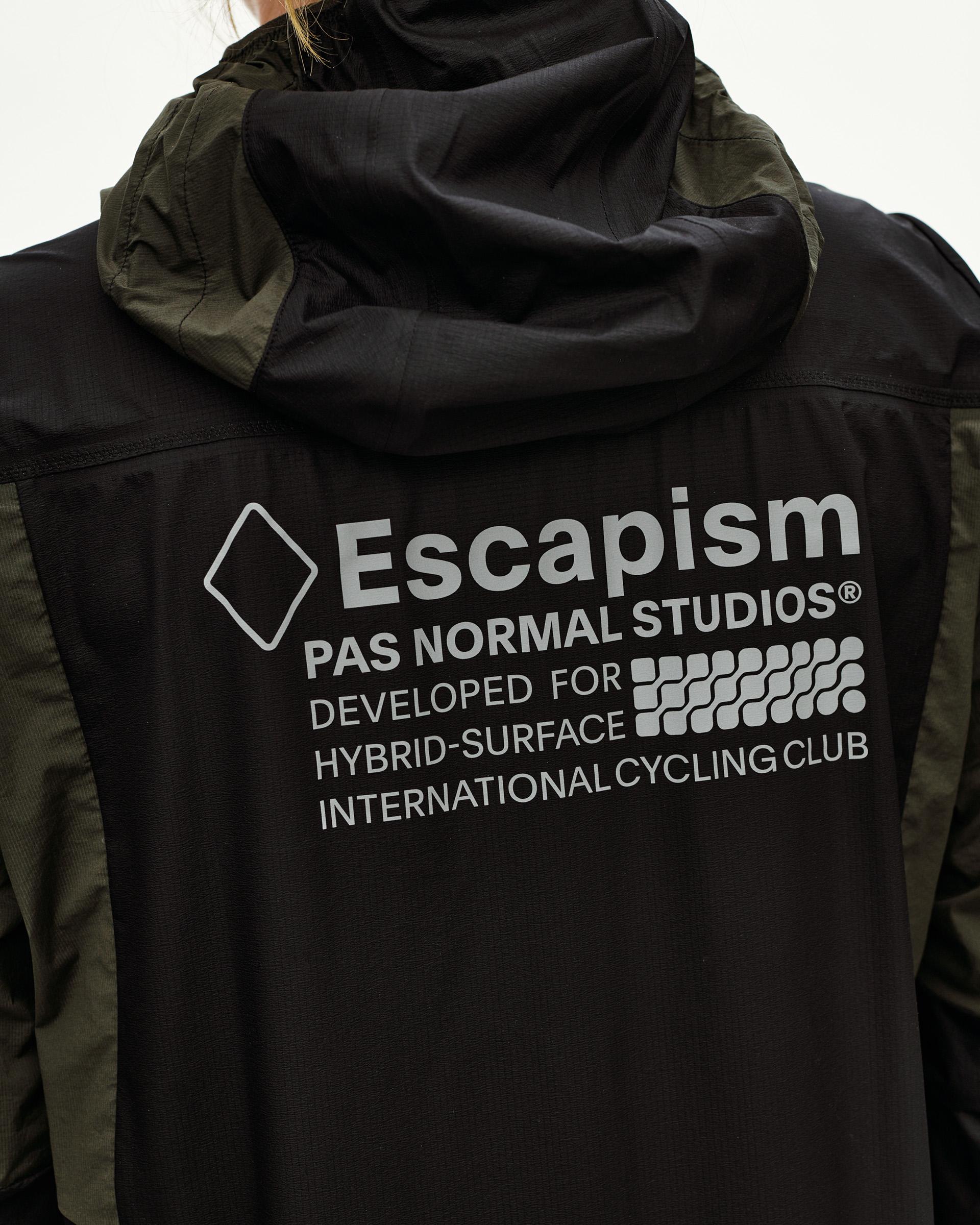 Black Escapism hooded lightweight jacket, rear detail on model with grey graphic back print and olive side panels