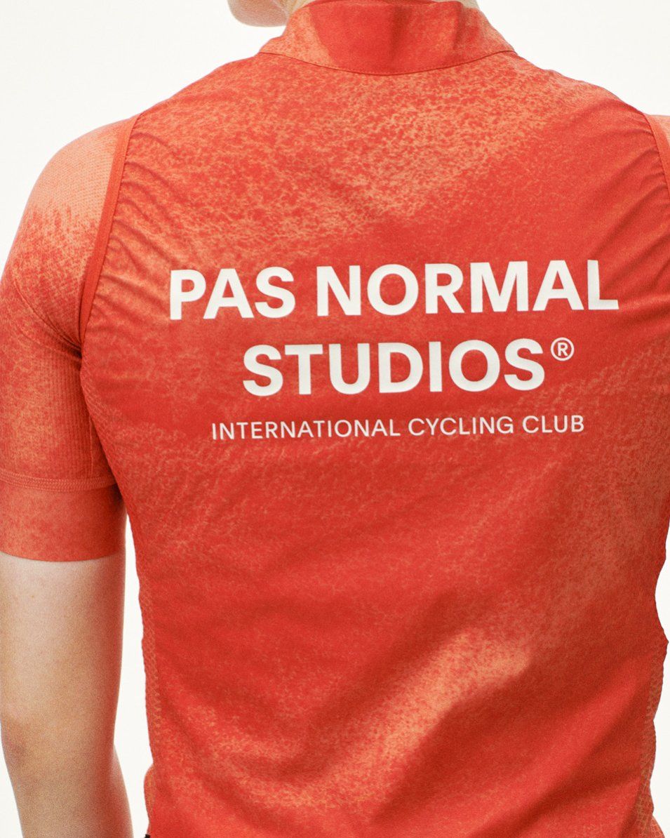 Orange Mechanism Stow Away gilet, rear view on model with white back logo