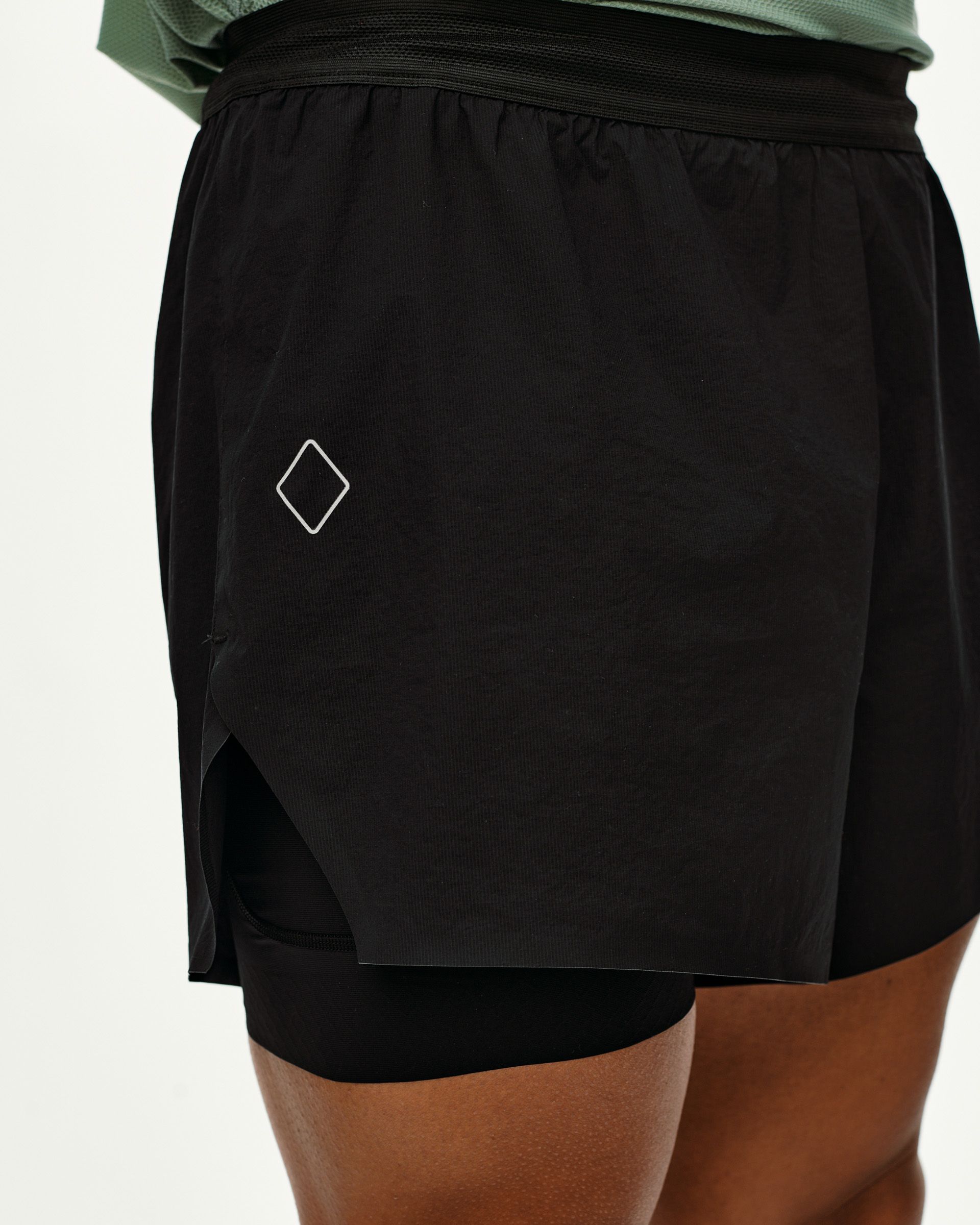 Black Balance 2-in-1 shorts, side detail on model with inner liner visible and diamond logo