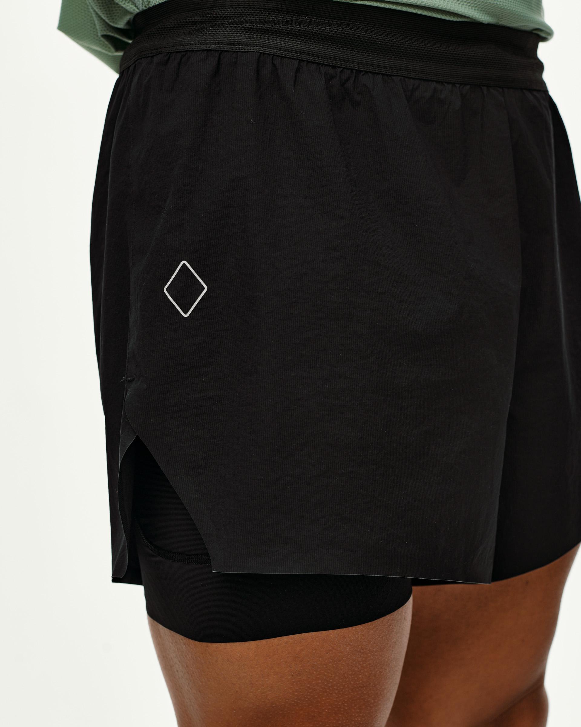 Black Balance 2-in-1 shorts, side detail on model with inner liner visible and diamond logo