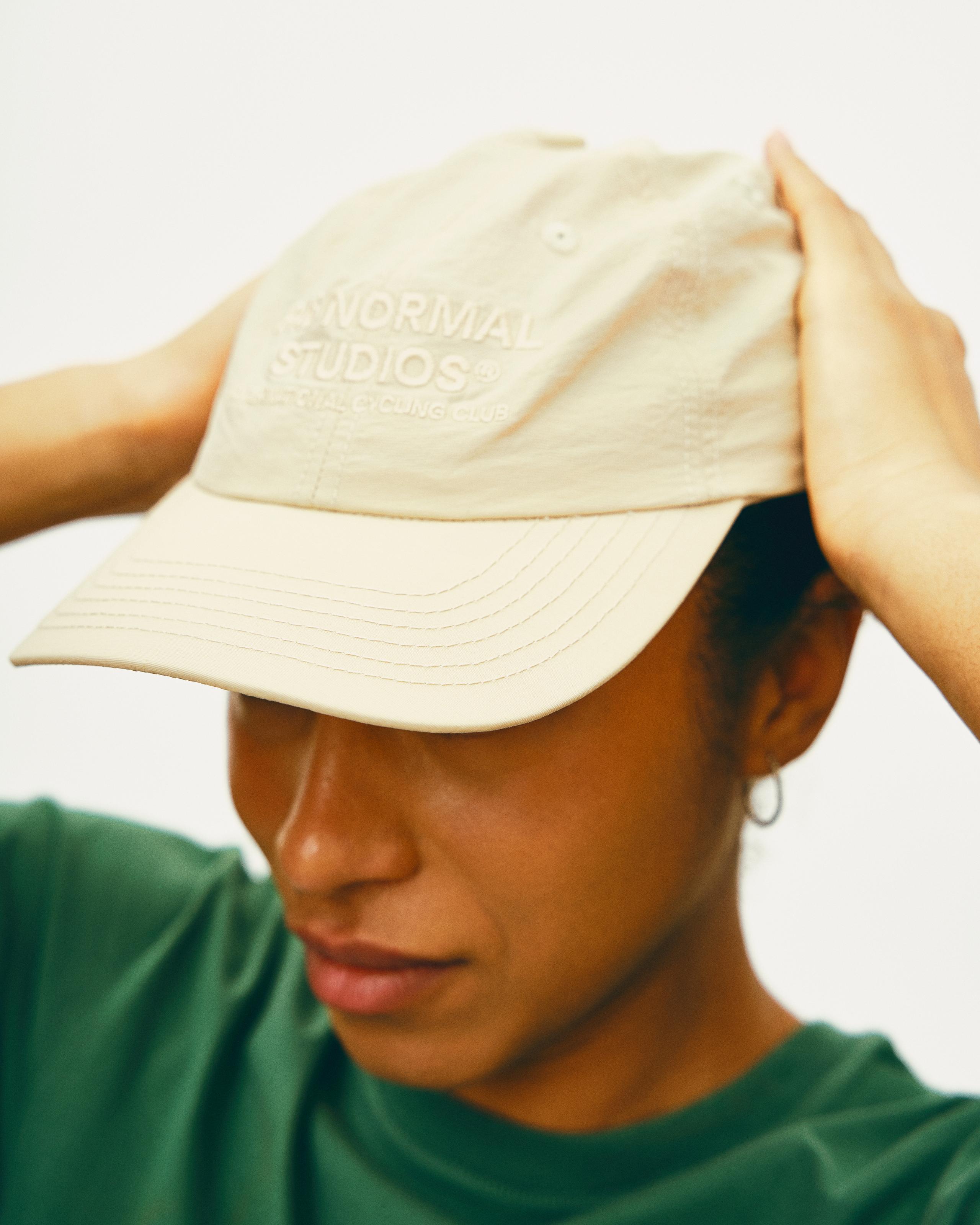 Limestone Off-Race cap on model, front view with embroidered text logo
