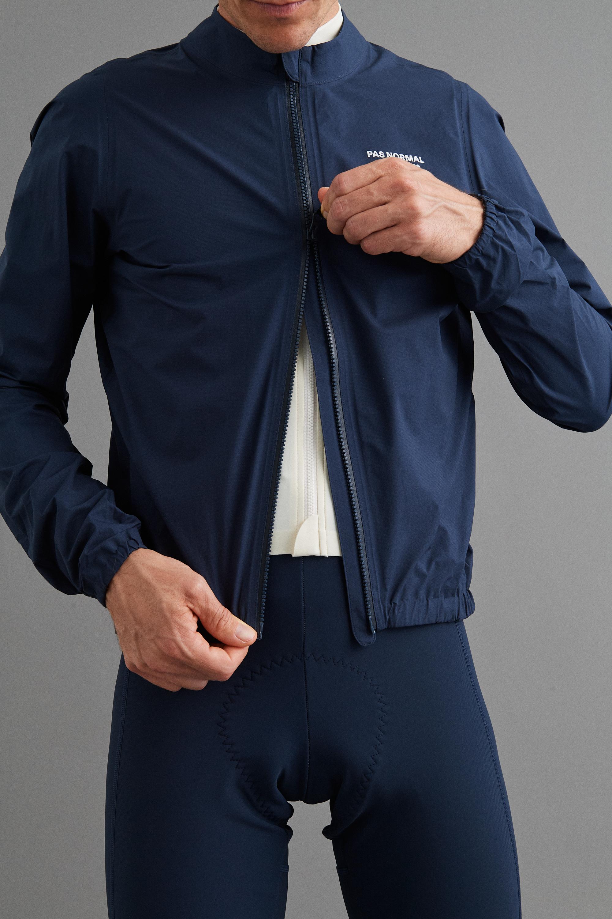 Navy Mechanism Pertex Rain cycling jacket on model, front view with white chest logo