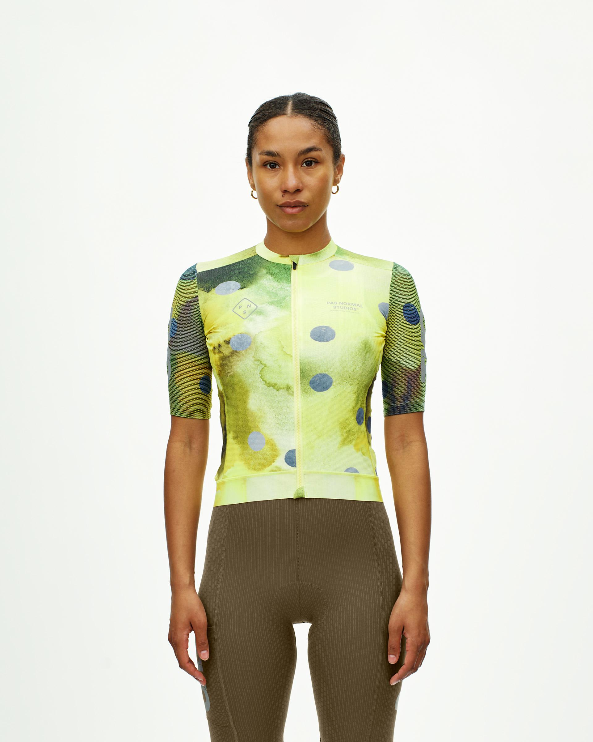 Yellow T.K.O. Essential Light cycling jersey on model with painted dot print and mesh sleeves