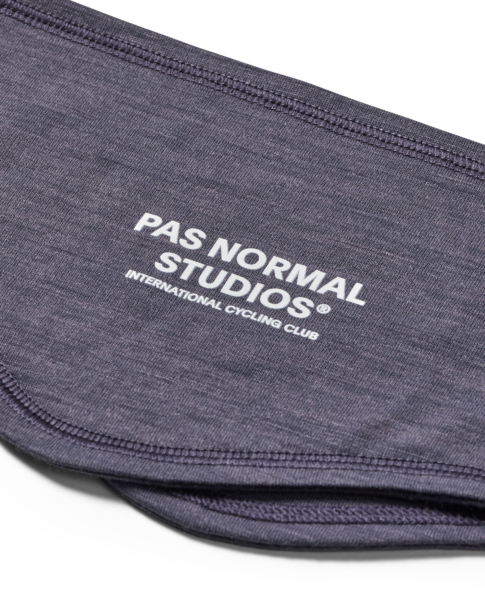 Grey Logo Merino headband, detail view showing white brand text and contrast stitching