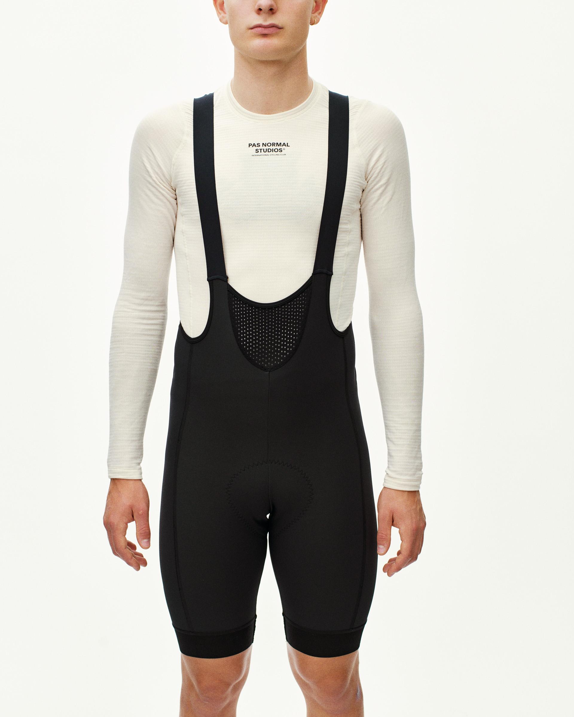 Black Mechanism Deep Winter cycling bibs on model with perforated chest panel and shoulder straps
