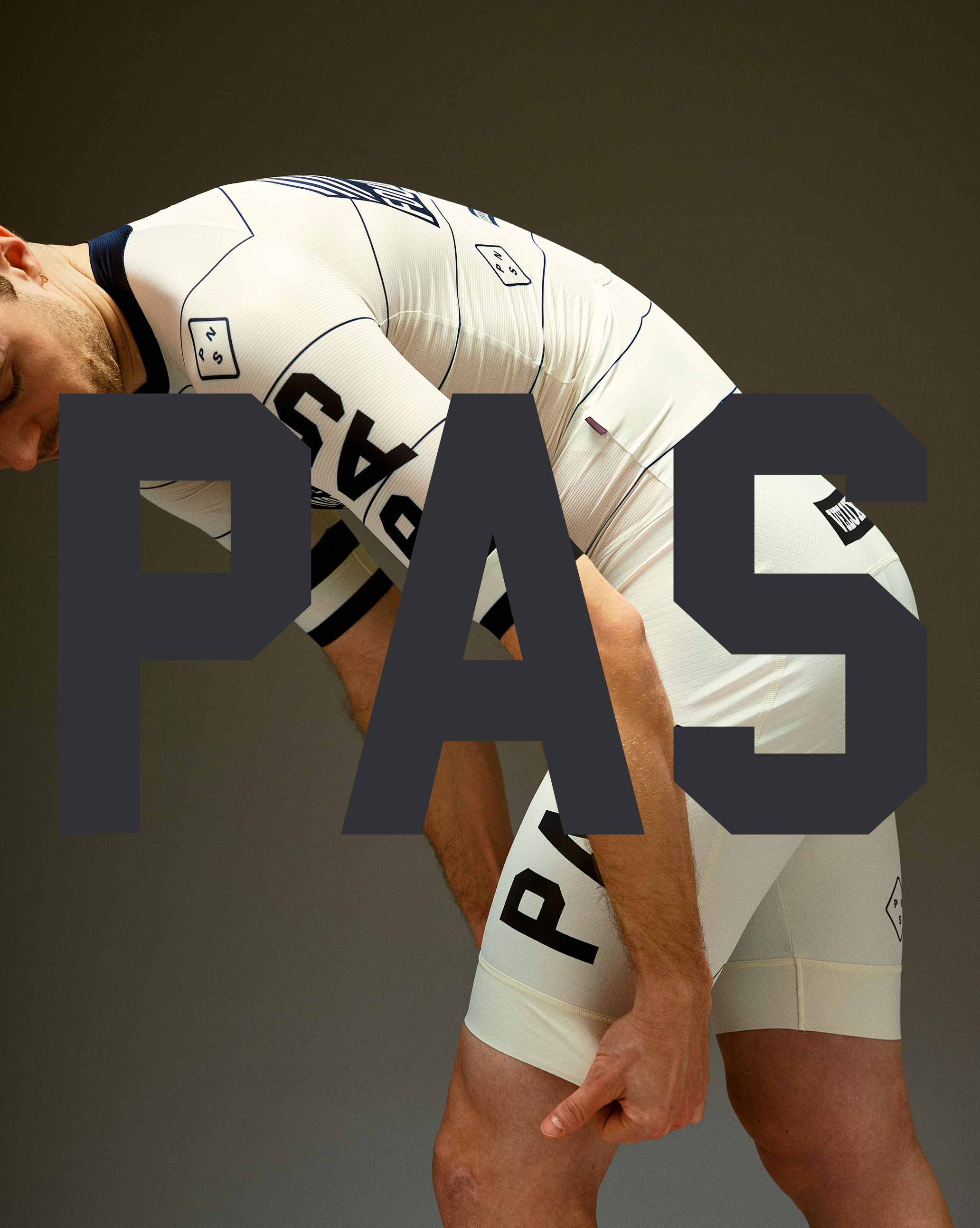 Model wearing Men's PAS Jersey in white with black text and geometric details