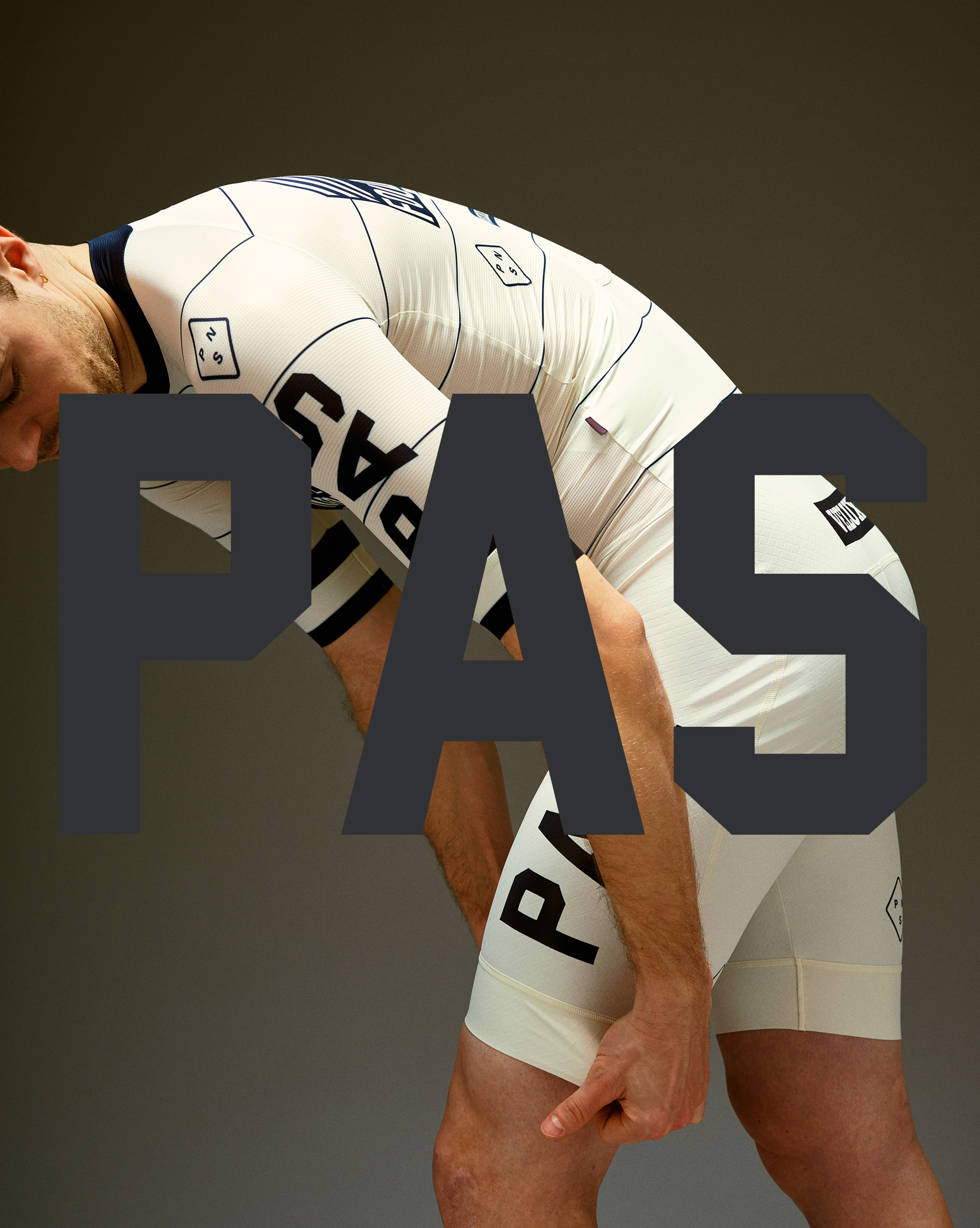 Model wearing Men's PAS Jersey in white with black text and geometric details