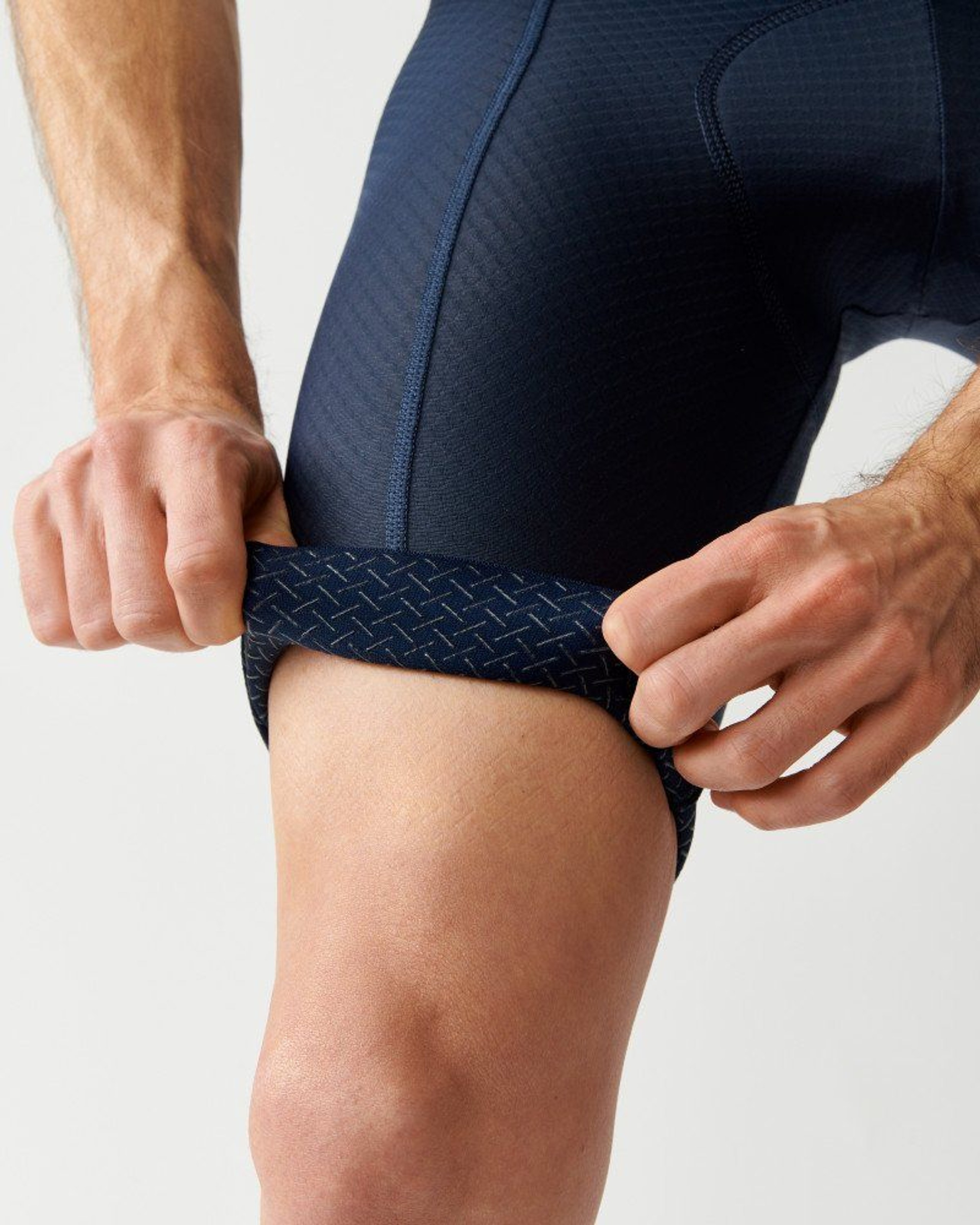 Navy Essential cycling bibs on model showing textured leg gripper hem