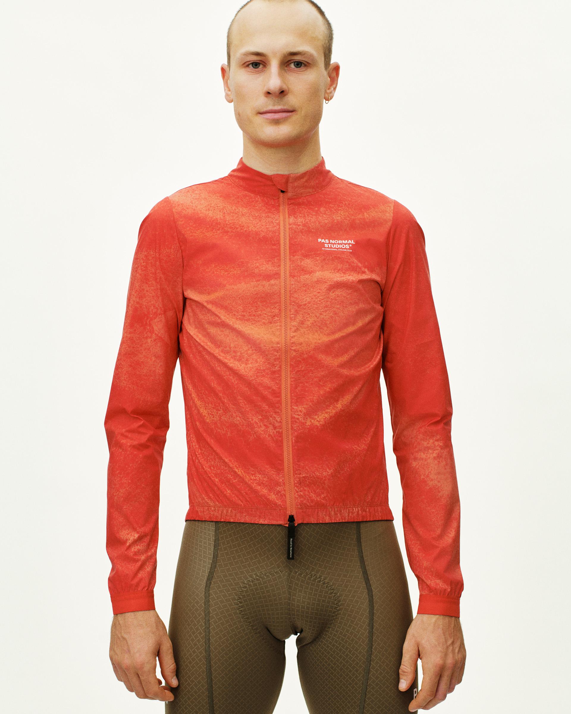Orange Mechanism Stow Away cycling jacket on model with textured lightweight fabric