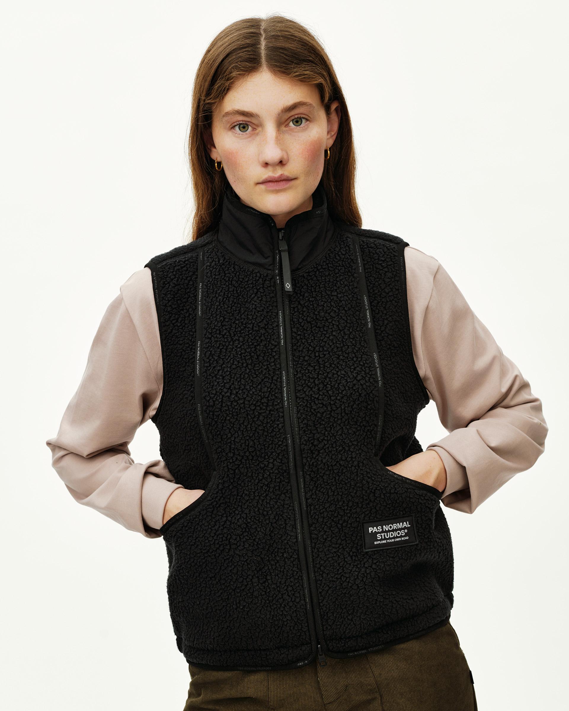 Black Off-Race Pile Fleece Vest on model, front view with full zip and branded patch at hem