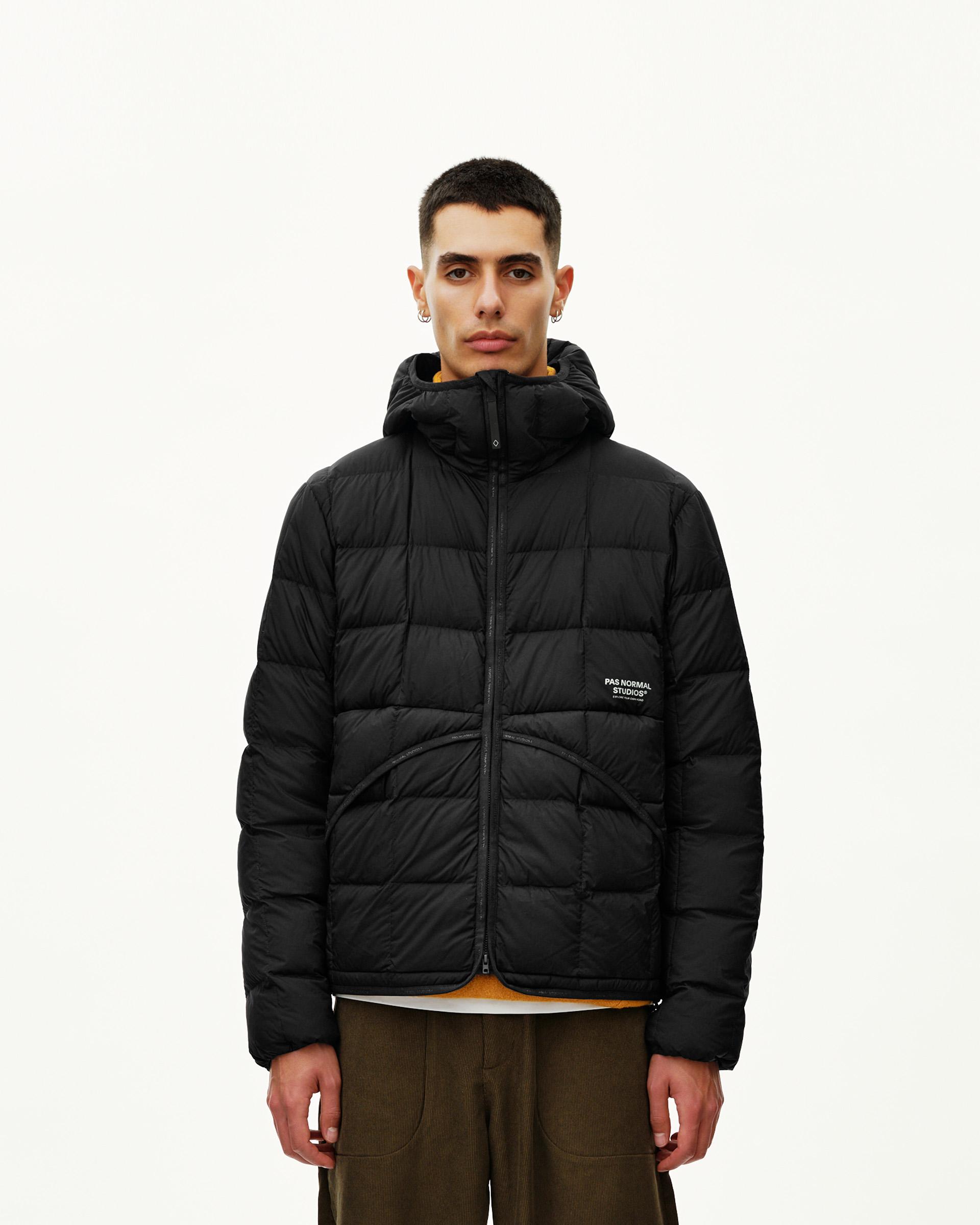 Black Off-Race Down Liner hooded jacket on model, front view with quilted panels and chest logo patch