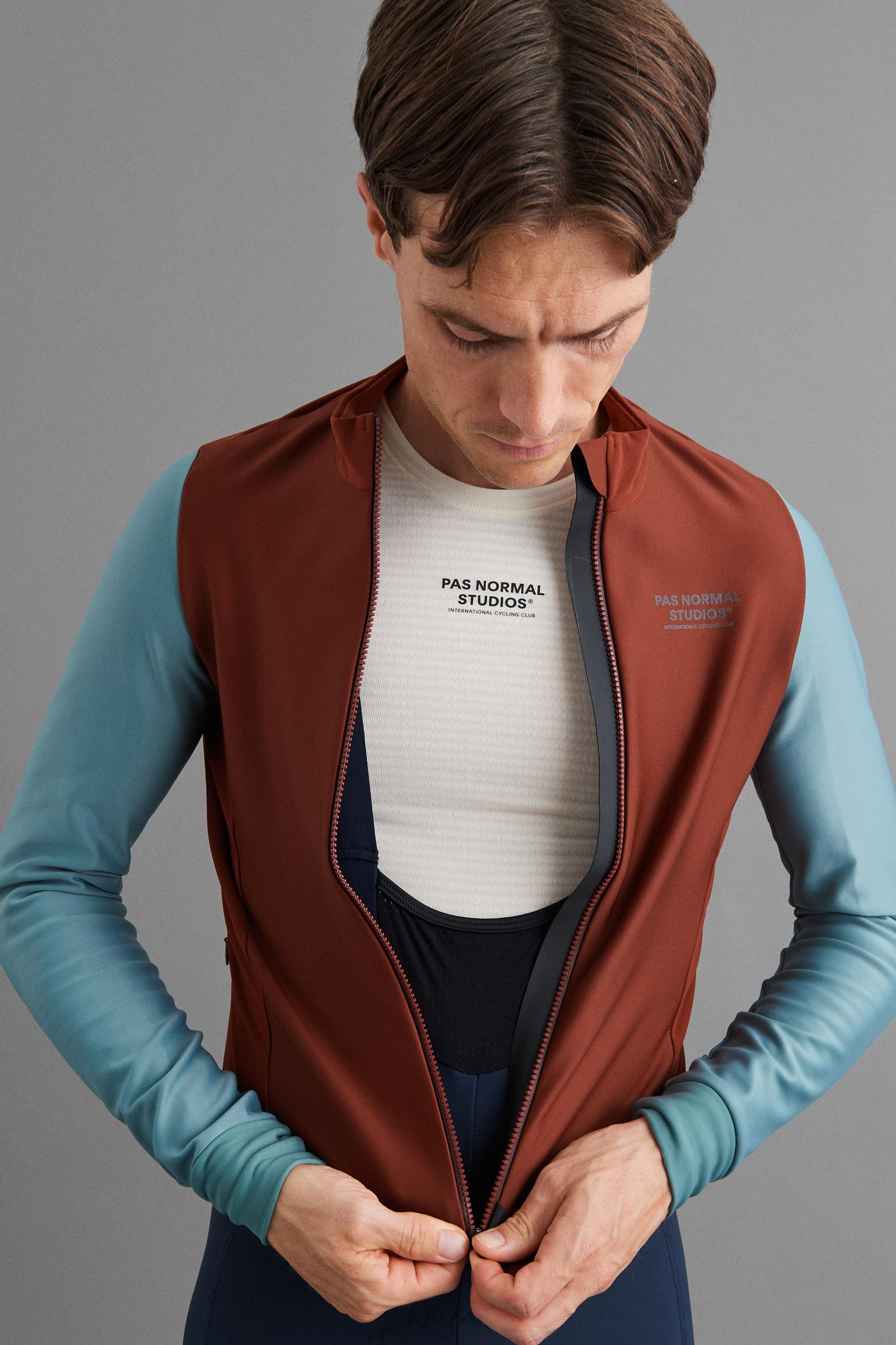 Mahogany Mechanism thermal long sleeve cycling jersey on model, front view with open zip and chest logo print