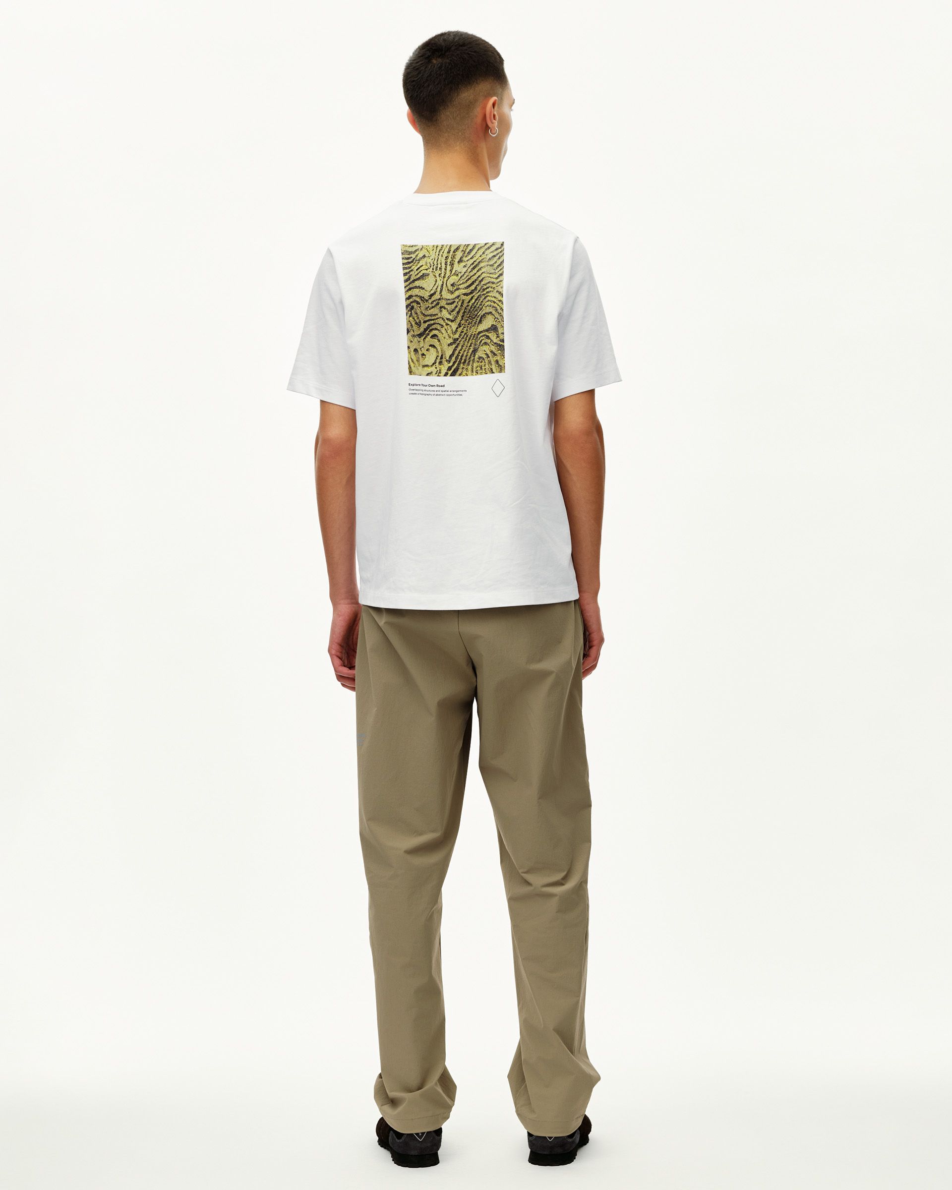 Dusty Earth khaki Off-Race Tech pants on model, rear view with straight leg and relaxed fit