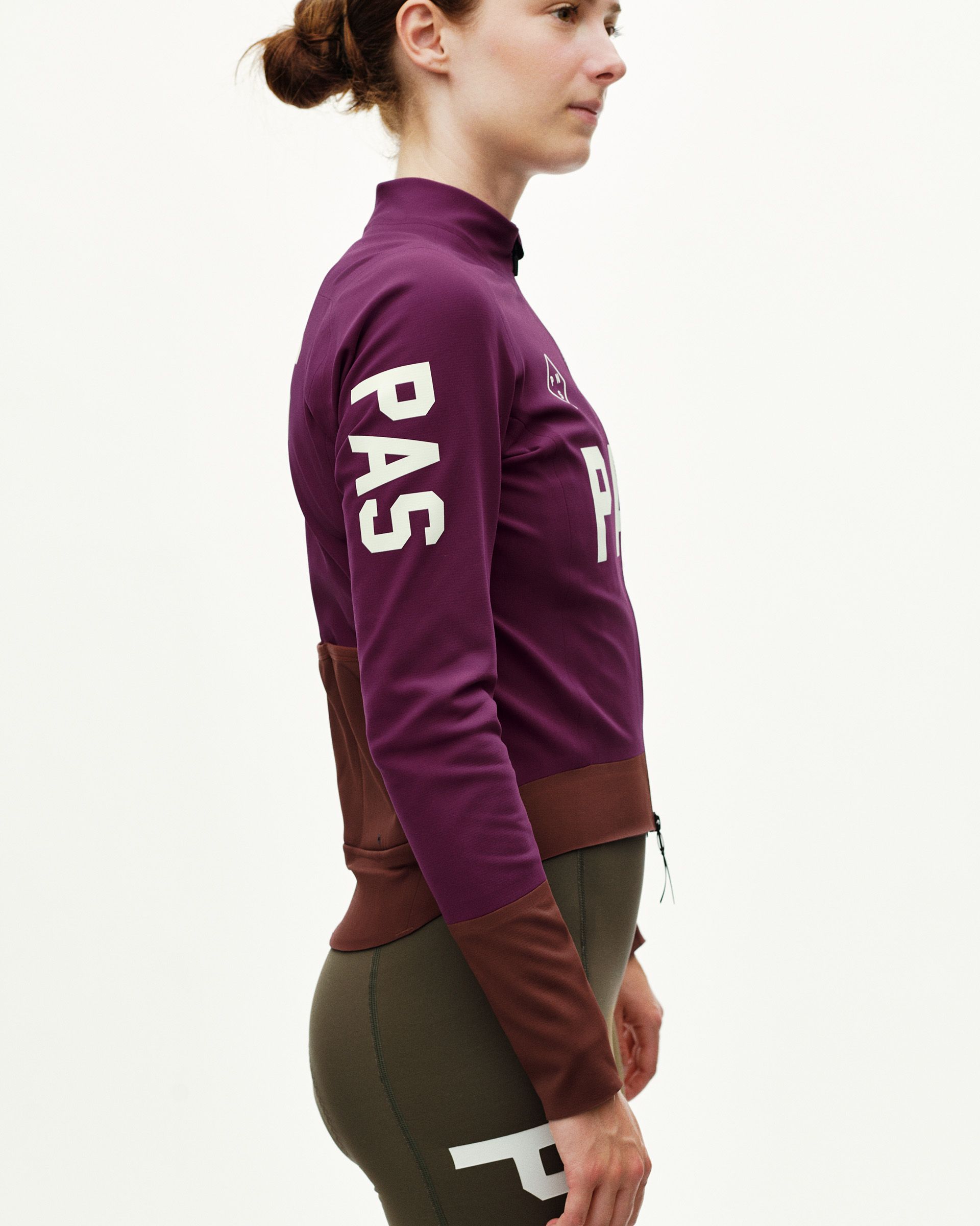 Dark Purple women's thermal cycling jacket, side view on model with brown colour-block lower panel and white arm print