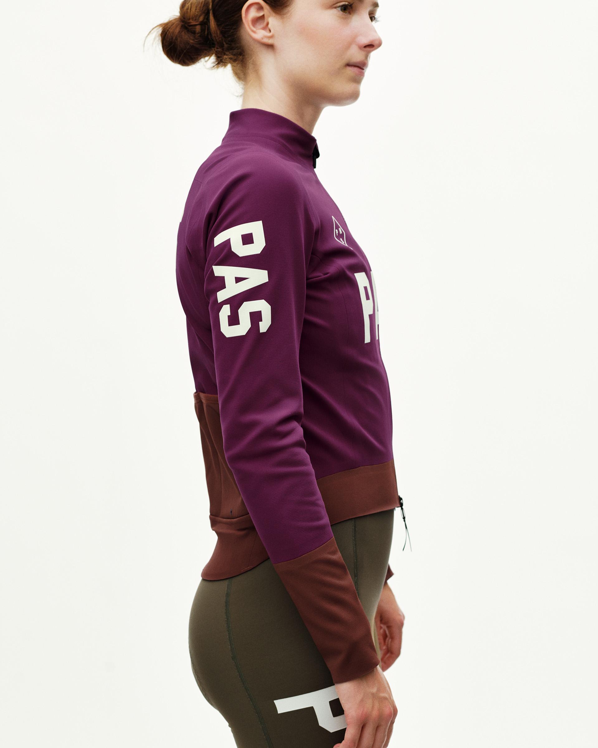 Dark Purple women's thermal cycling jacket, side view on model with brown colour-block lower panel and white arm print