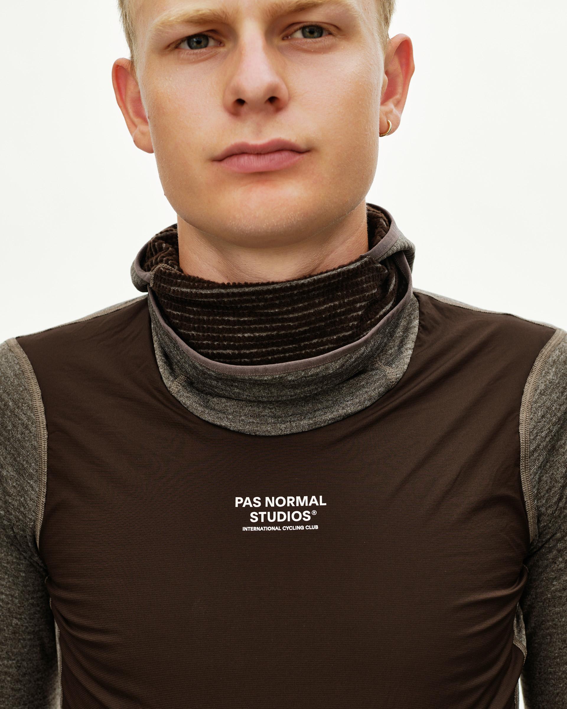 Dark Coffee brown cycling base layer on model, front detail view with ribbed turtleneck collar and white chest logo
