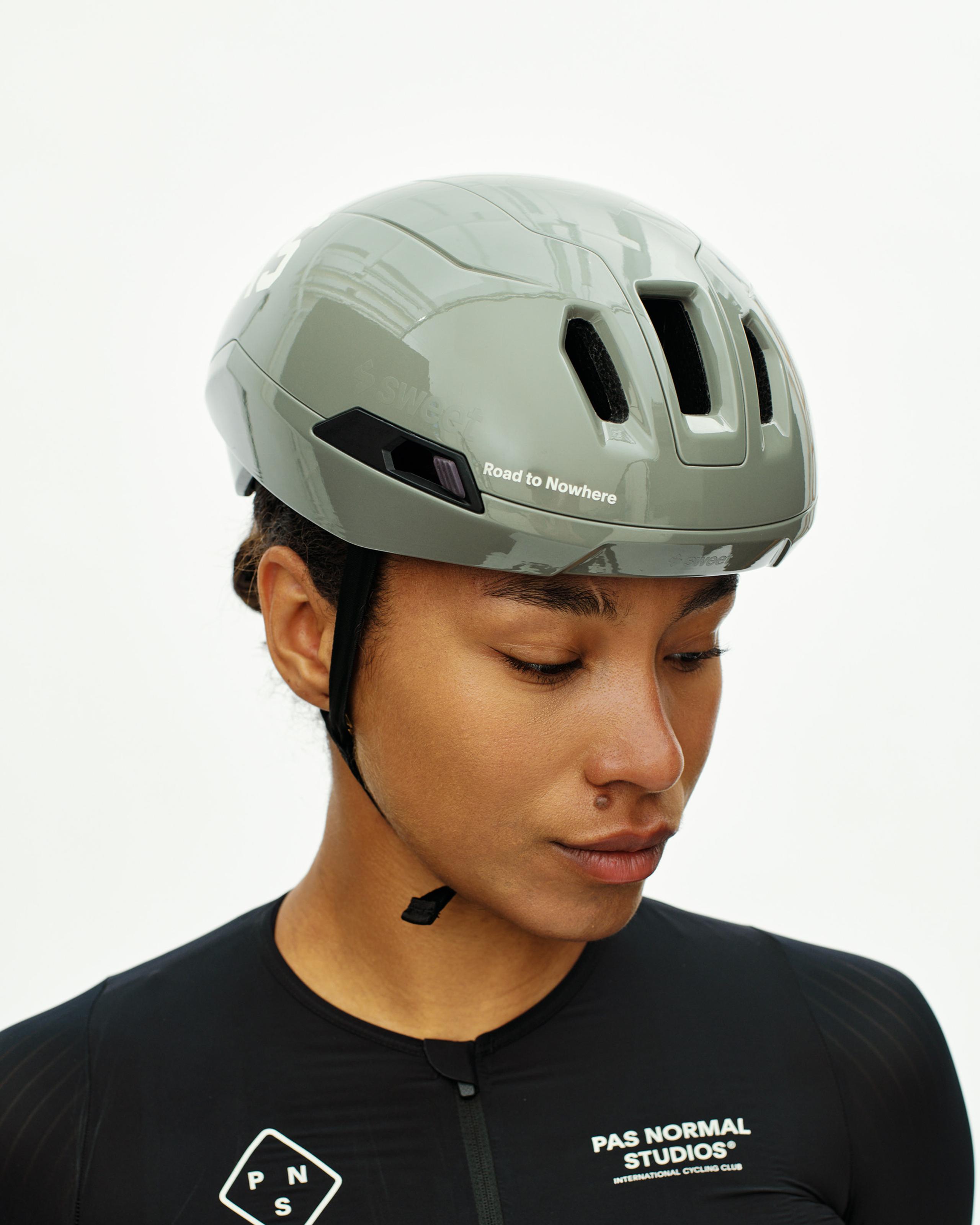 Grey PAS Tucker III 2Vi MIPS cycling helmet on model with Road to Nowhere side text