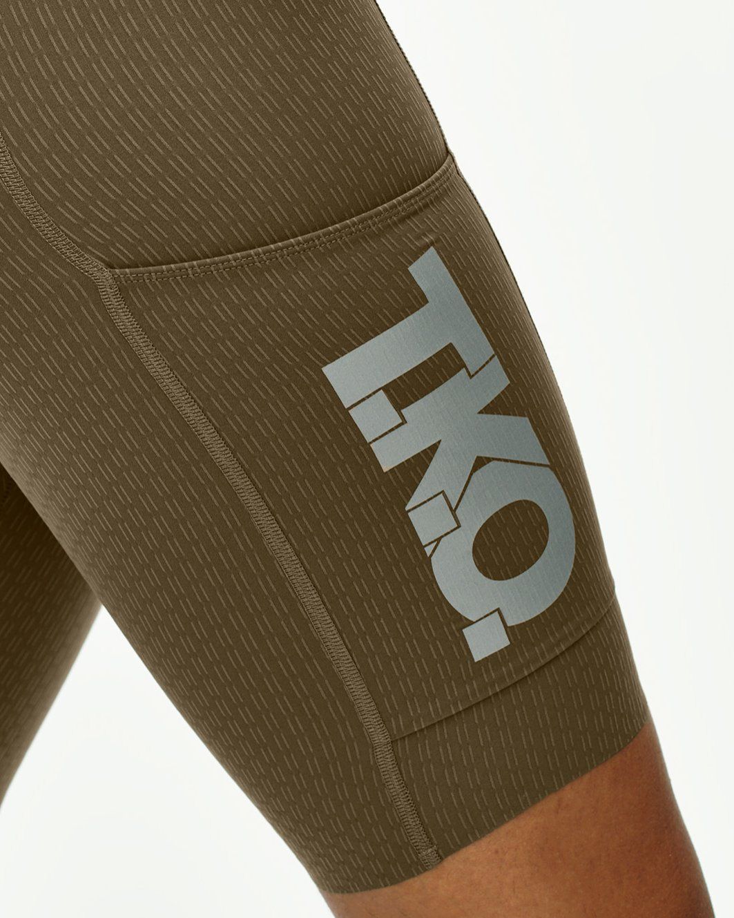 Brown T.K.O. Essential Light Cargo bibs on model with grey logo print on thigh
