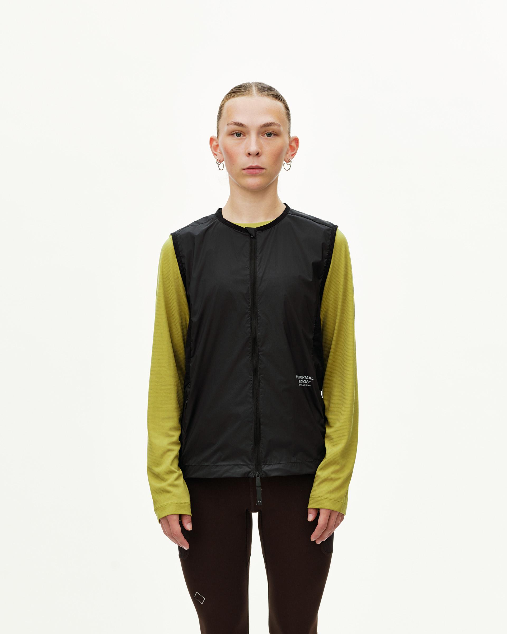 Black Balance Windproof vest on model, front view with centre zip and small chest logo print