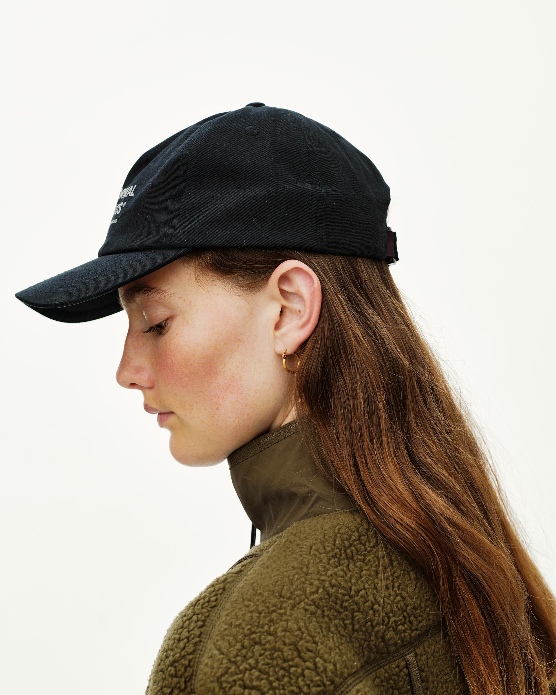 Black Off-Race Cotton Cap on model, side view with white text embroidery on front panel
