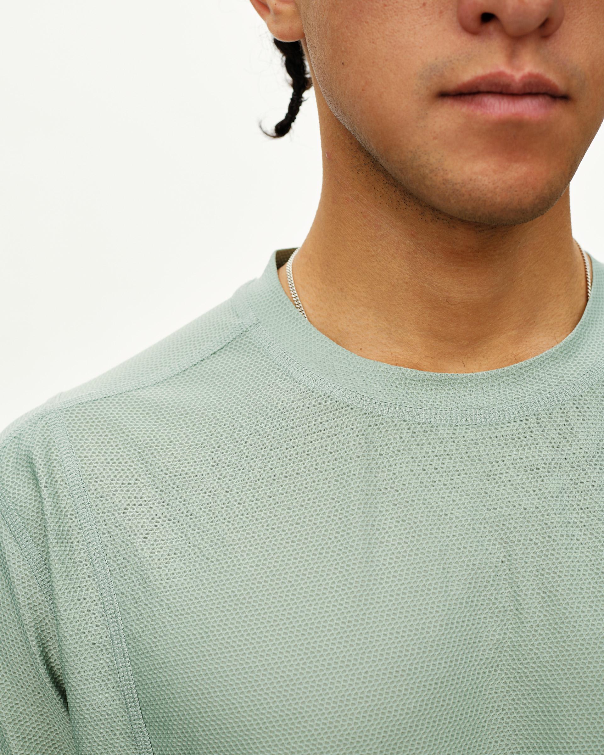 Green Sage Balance T-shirt on model, front detail view with textured fabric and crew neck